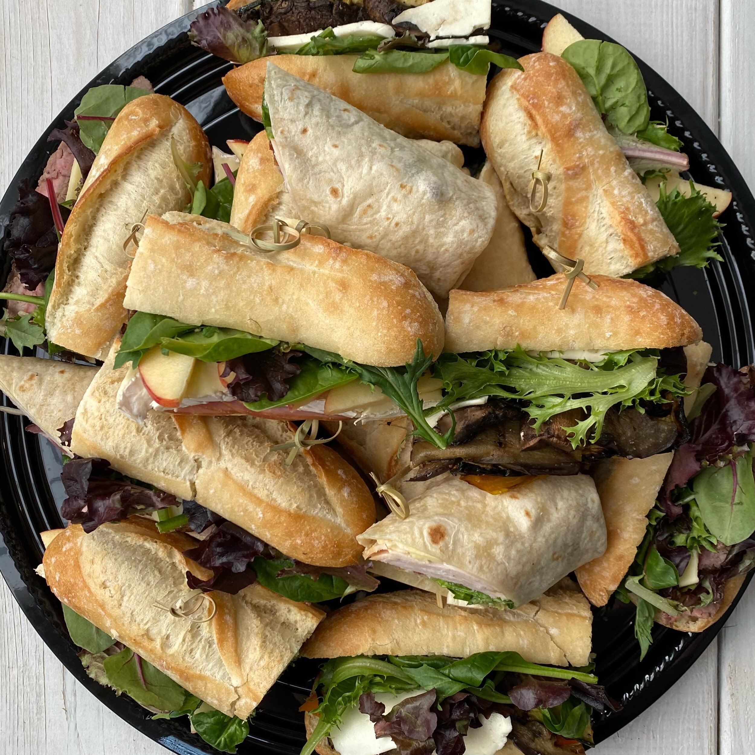 We assemble our sandwiches on fresh, toasted bread on the morning of your event because it really does make a difference. Say no to chewy, soggy sandwiches! Pictured here: Ham, Brie, &amp; Fuji apple, turkey bacon club wrap, &amp; grilled eggplant, z