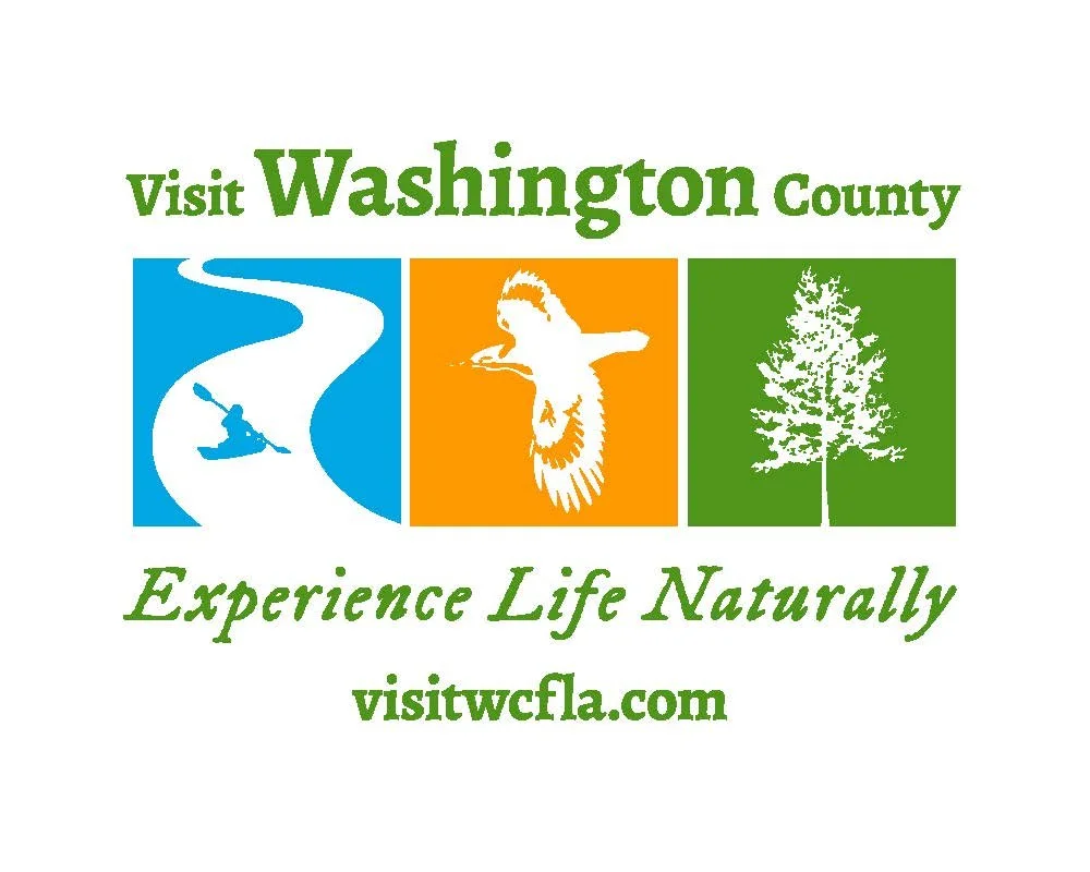 A promotional graphic for Washington County with icons of kayaking, a bird, and a tree, and the text "Visit Washington County," "Experience Life Naturally," and the website "visitwcla.com."
