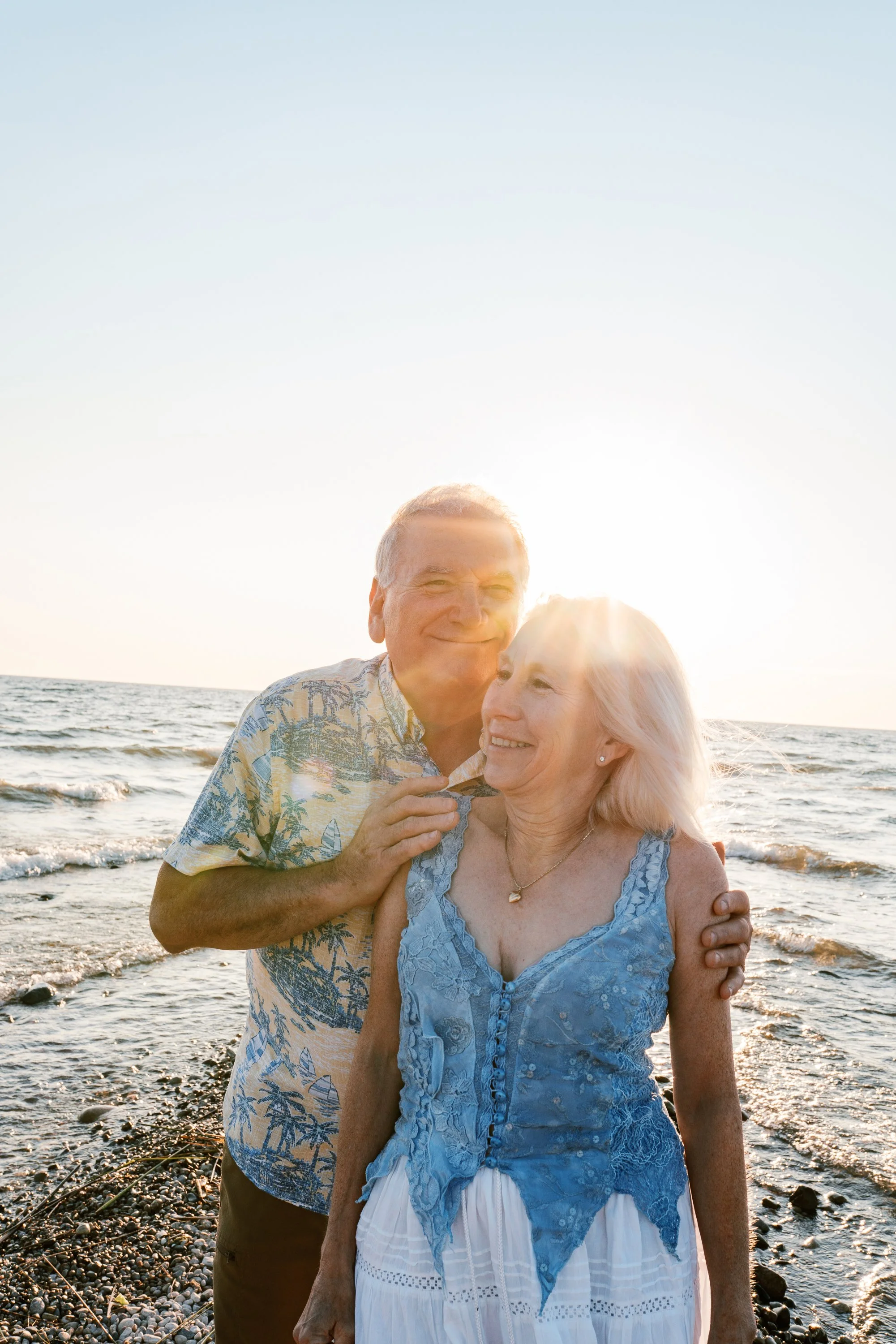 Close-up portrait of a smiling couple backlit by the sun on the Atlantic City Beach