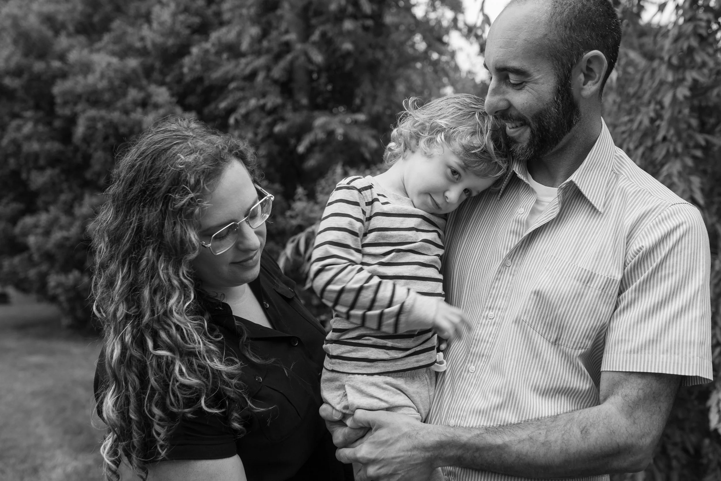Black and white portrait of a toddler leaning on his father's shoulder at a Haddonfield family reunion