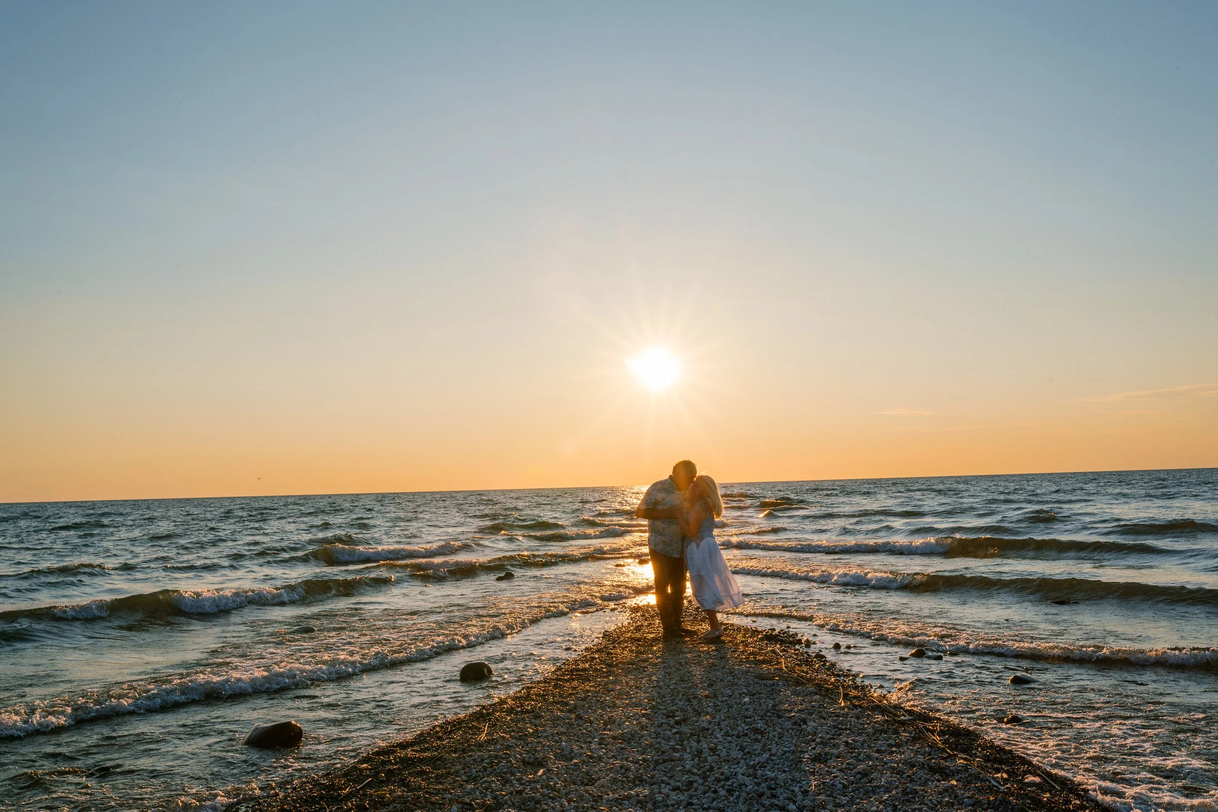Silhouetted couple kissing at sunset on the Beach at Strathmere, New Jersey Shore anniversary photos