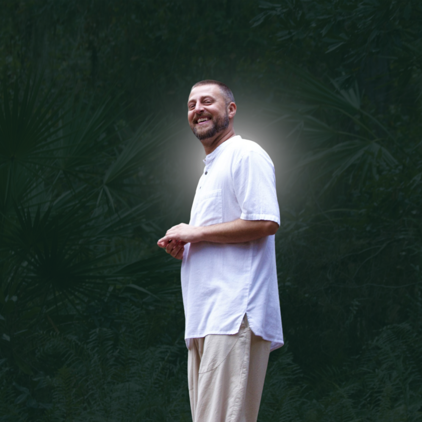 Andrew J. Assini spiritual guide and teacher standing outdoors smiling in white shirt