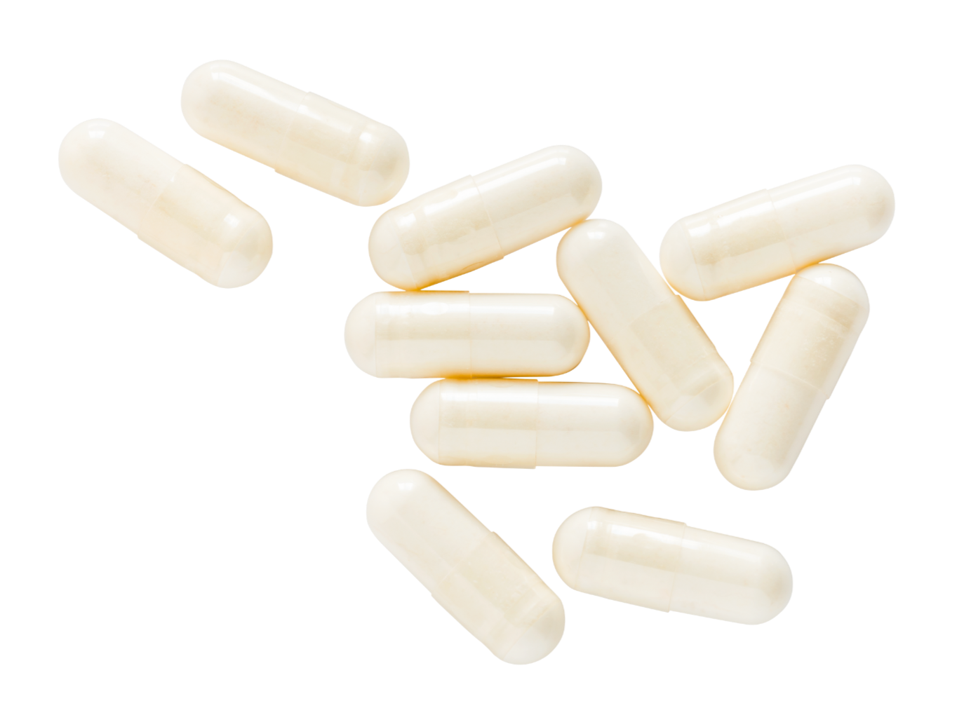 Several white capsules or pills scattered on a surface.