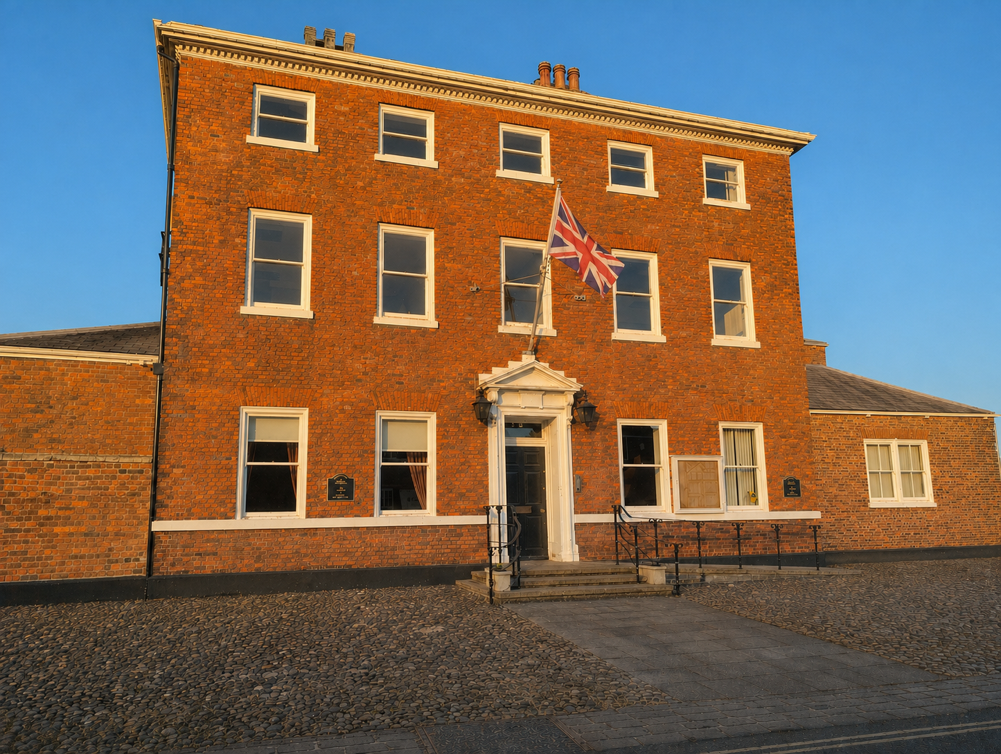 Front of Walkergate House, a large red-brick listed building with a flagpole, home to Earth Life Therapy in Beverley.
