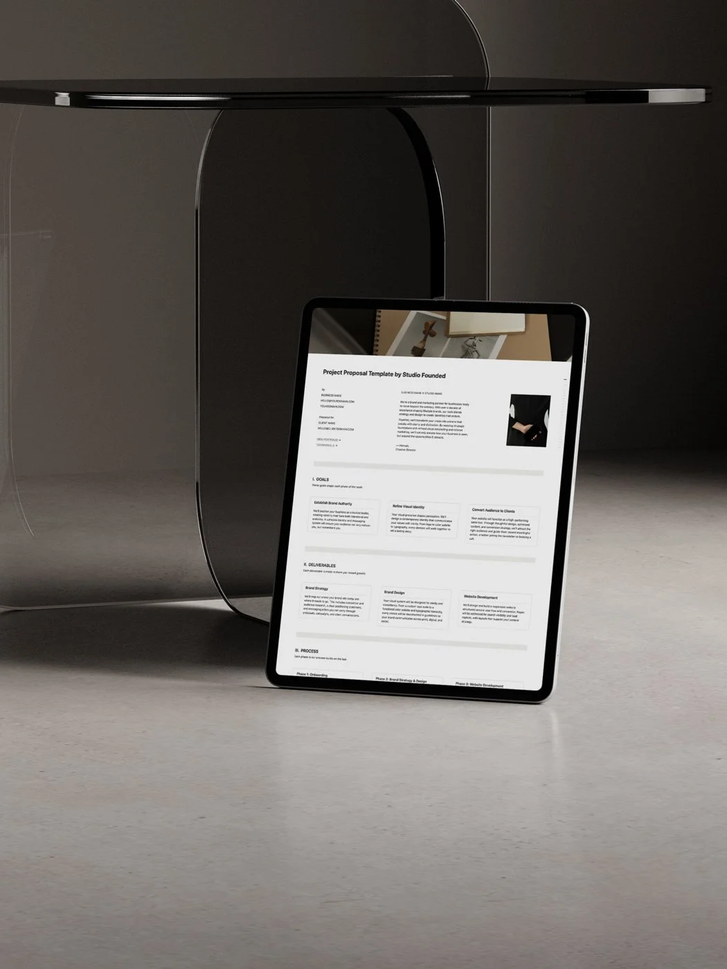 The Notion Project Proposal Template displayed an upright iPad beside a table.