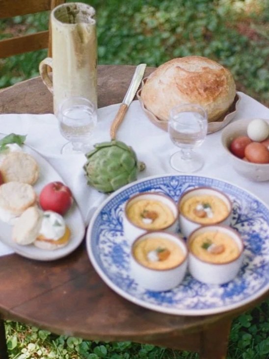 A webpage design with a section titled "Savor" and a photo of a table with and baked goods.
