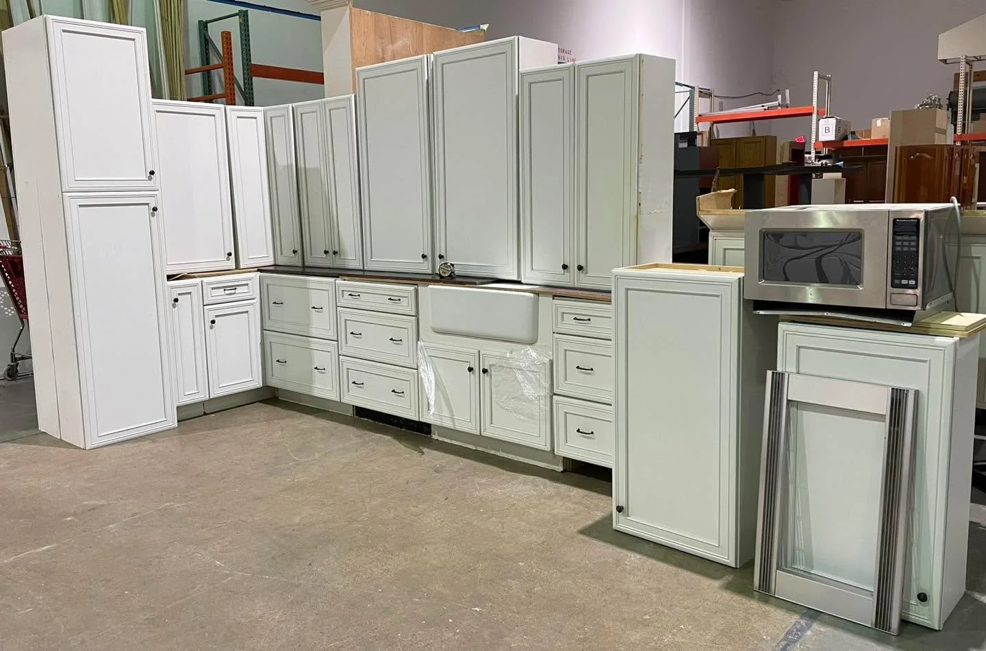 White kitchen cabinet set $1750 - about 16&rsquo; of base cabinets, includes microwave and apron sink at no additional charge. Not sold separately.