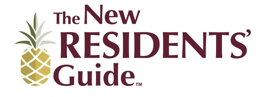 Group of people wearing construction helmets gathered in front of a newly built house, holding a sign that reads 'Westhaven Community Build,' with building materials stacked nearby.