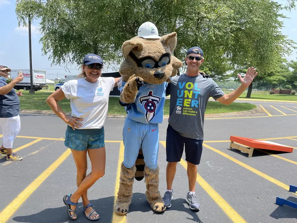 Two Volunteers with a Mascot