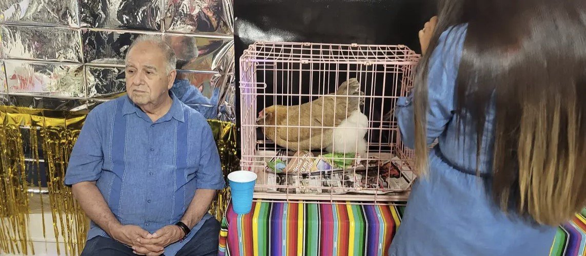 Dia del Nino festival 2023. Mr. Reynaldo Arrieta with his chicken Henrietta educating children on the life cycle of the egg.