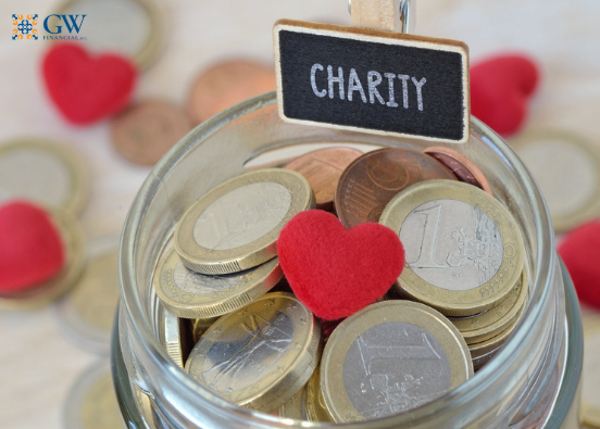 Jar full of coins with a heart and charity sign