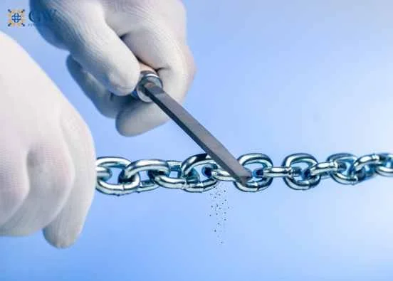 Hands filing a chain sabotaging the security of the links