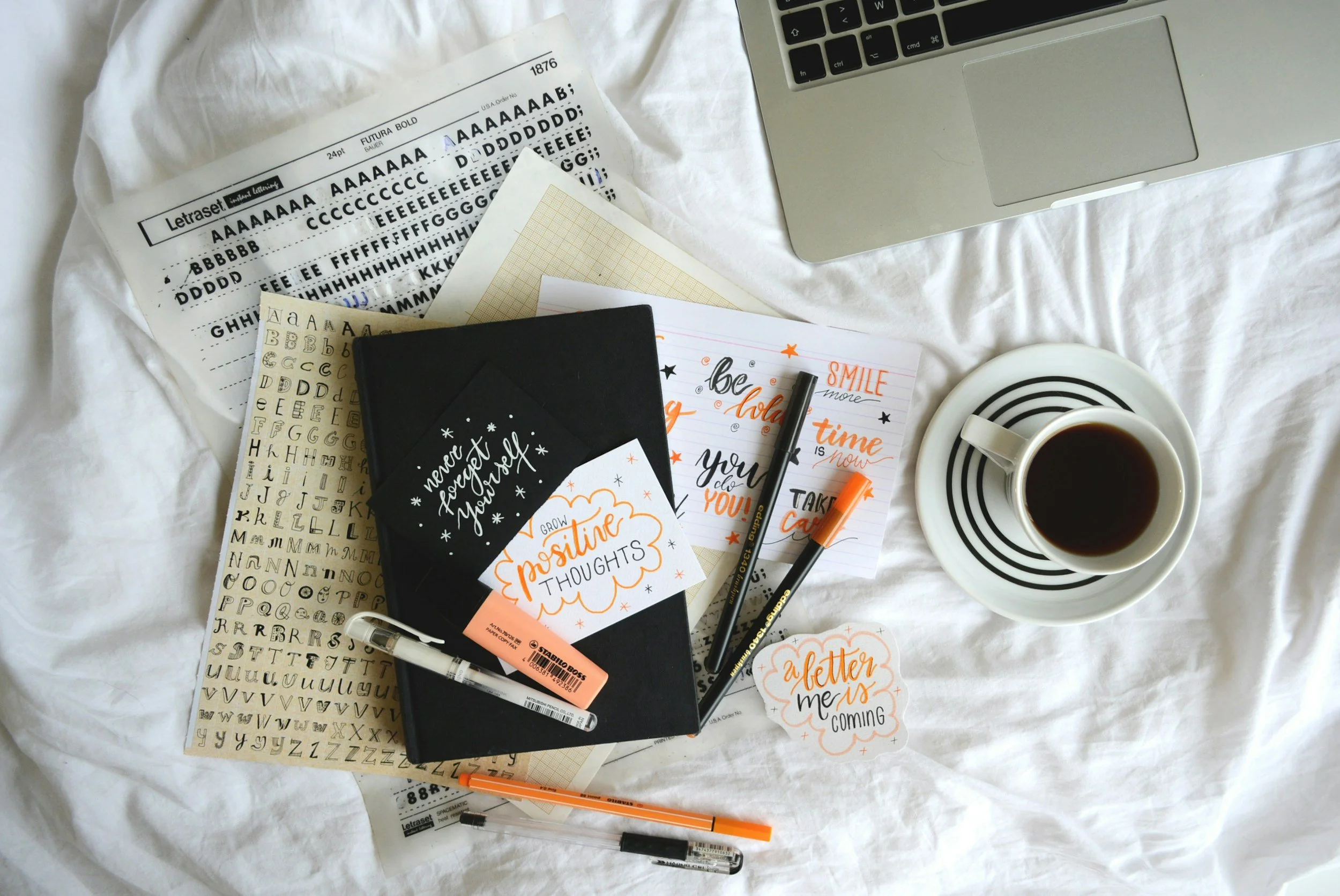 Journaling essentials for self-care: a notebook, pens, and inspiring quotes, promoting mental wellness and reflection.