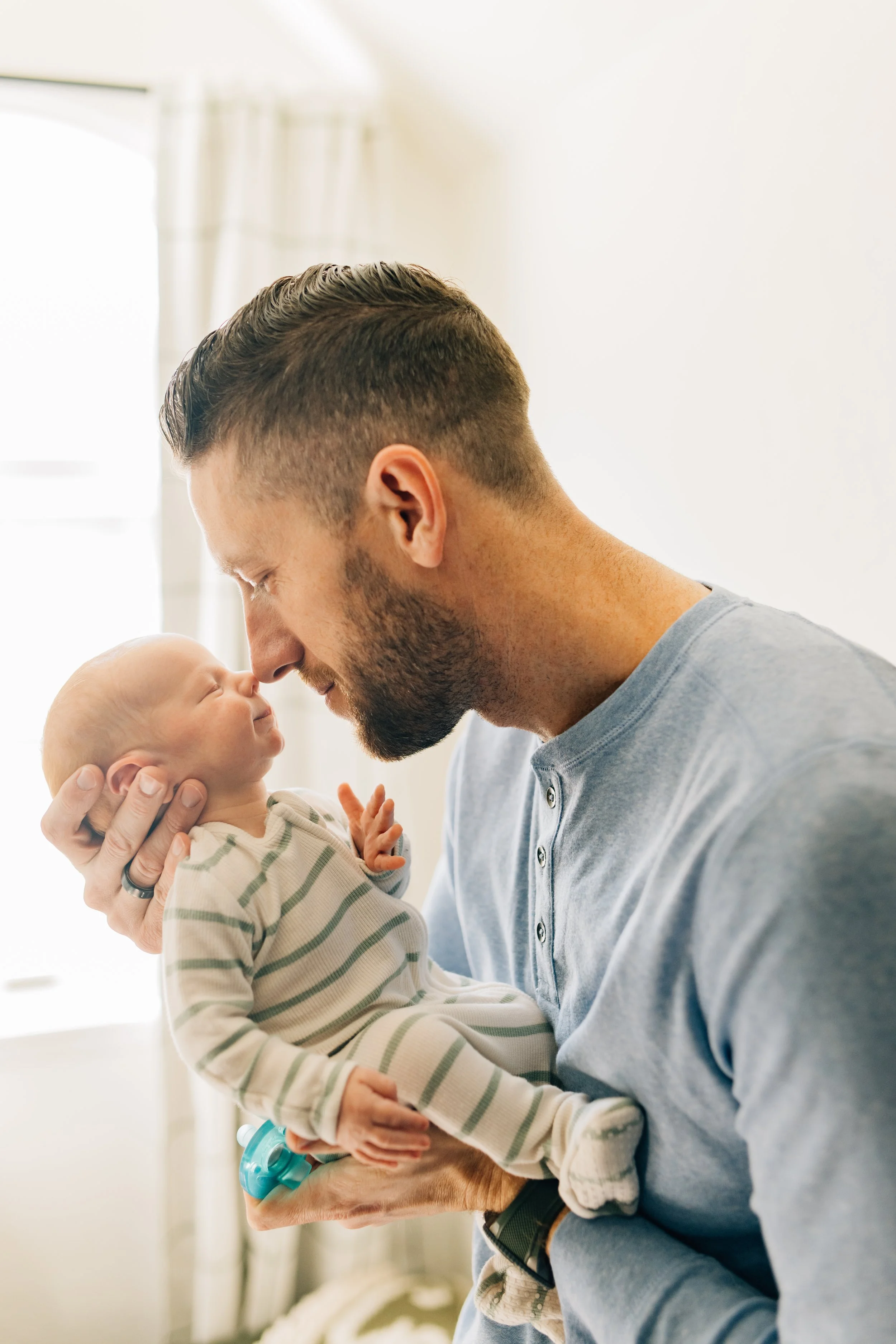 dad with newborn in nursery lifestyle photography session OKC