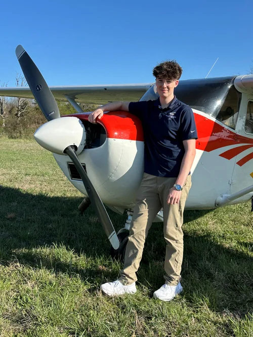 EMDA’s 2025 scholarship recipient standing beside a small airplane