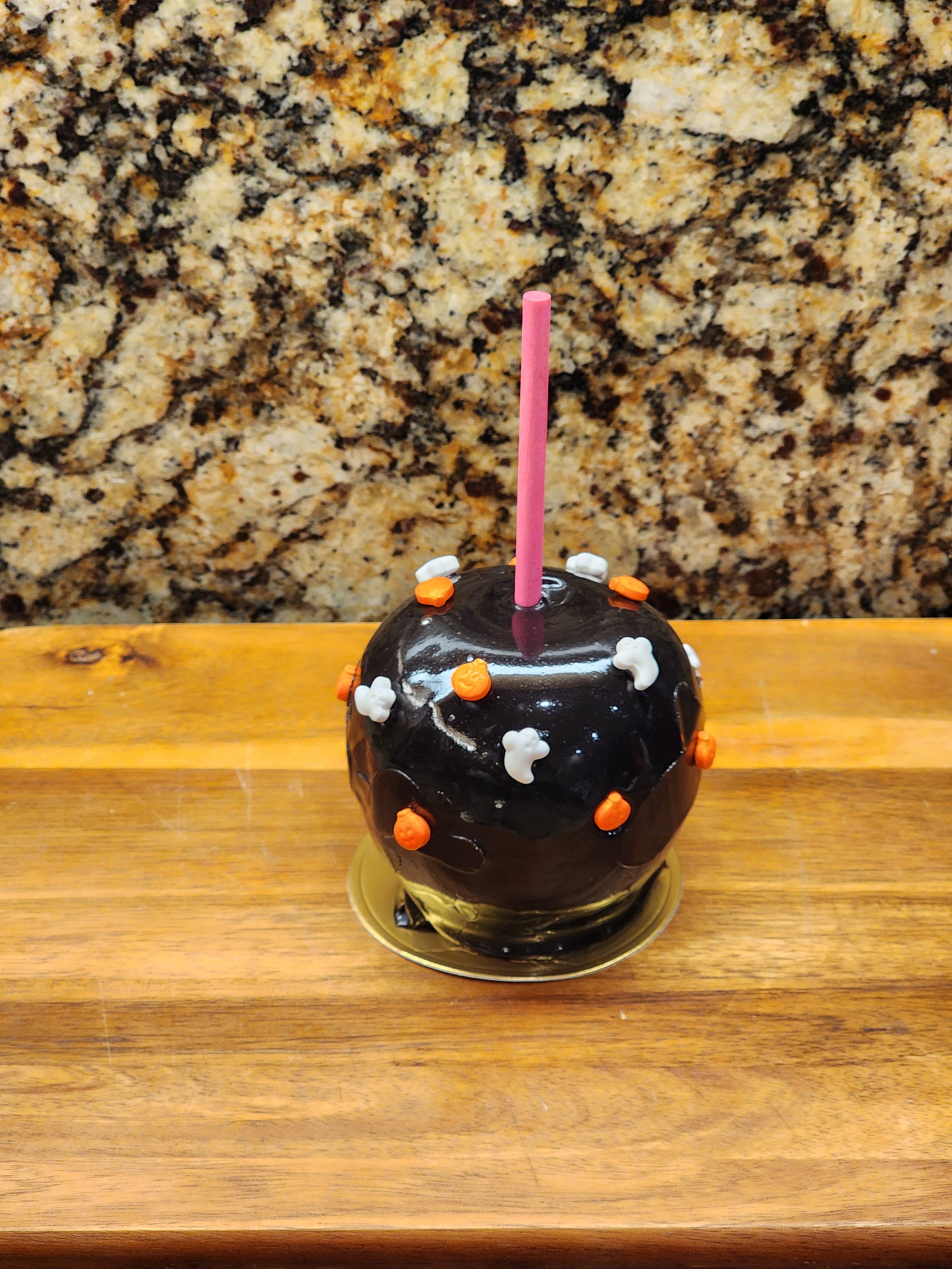 Black caramel apple with Halloween sprinkles.jpg
