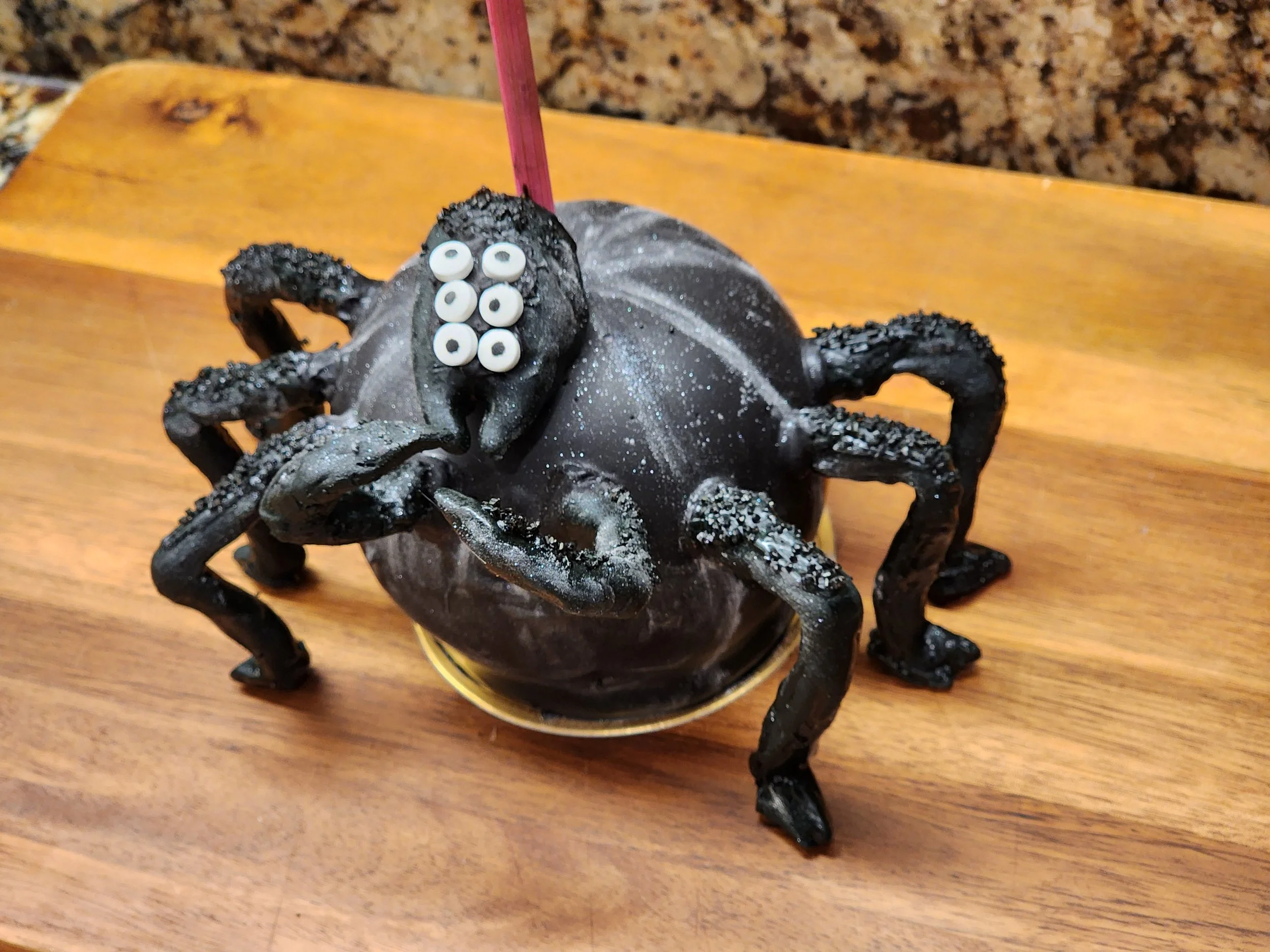 Black spider chocolate caramel apple with pretzel legs.jpg