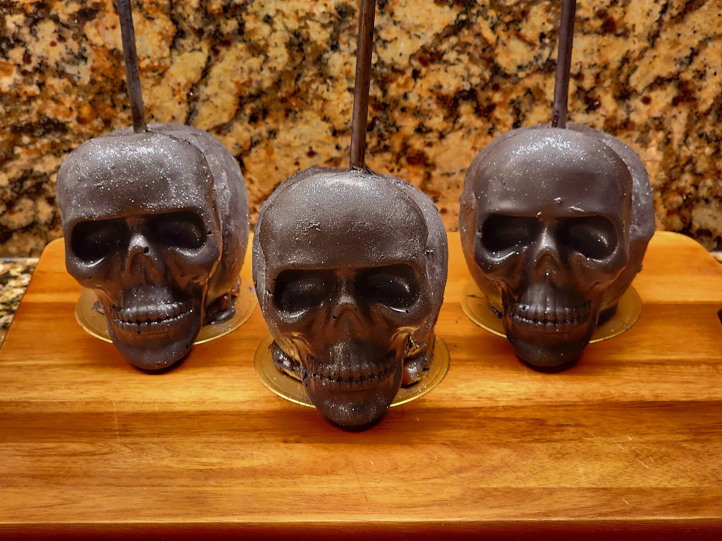 Black & silver chocolate skull-shaped caramel apple.jpg