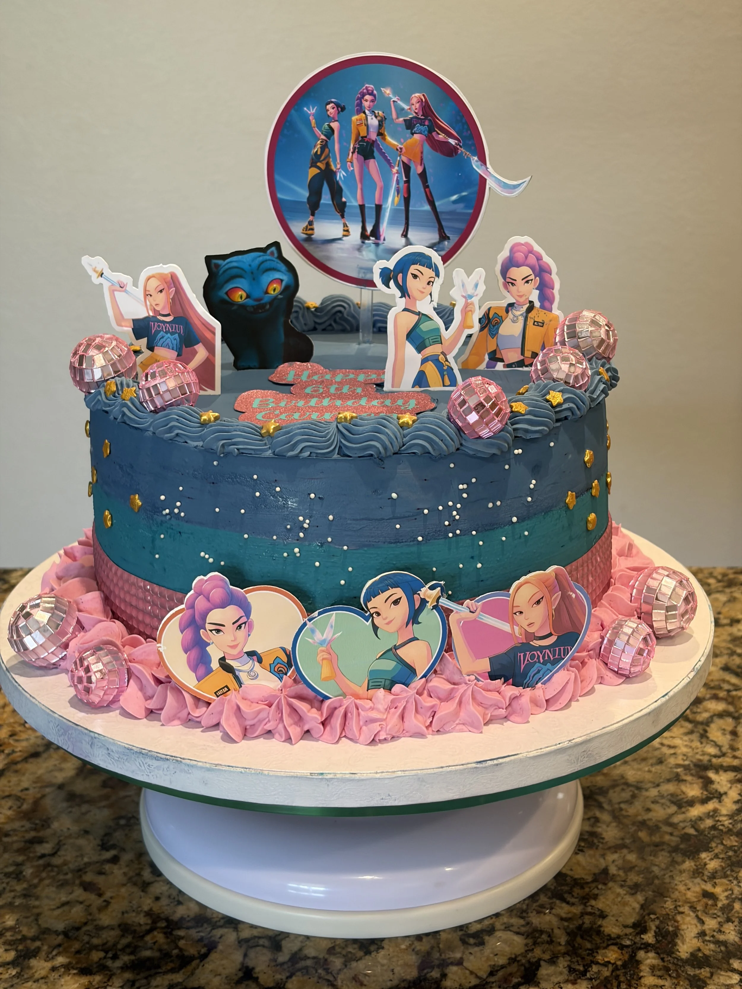Mermaid-themed 9-inch cake in teal and pink with character figures and a photo topper