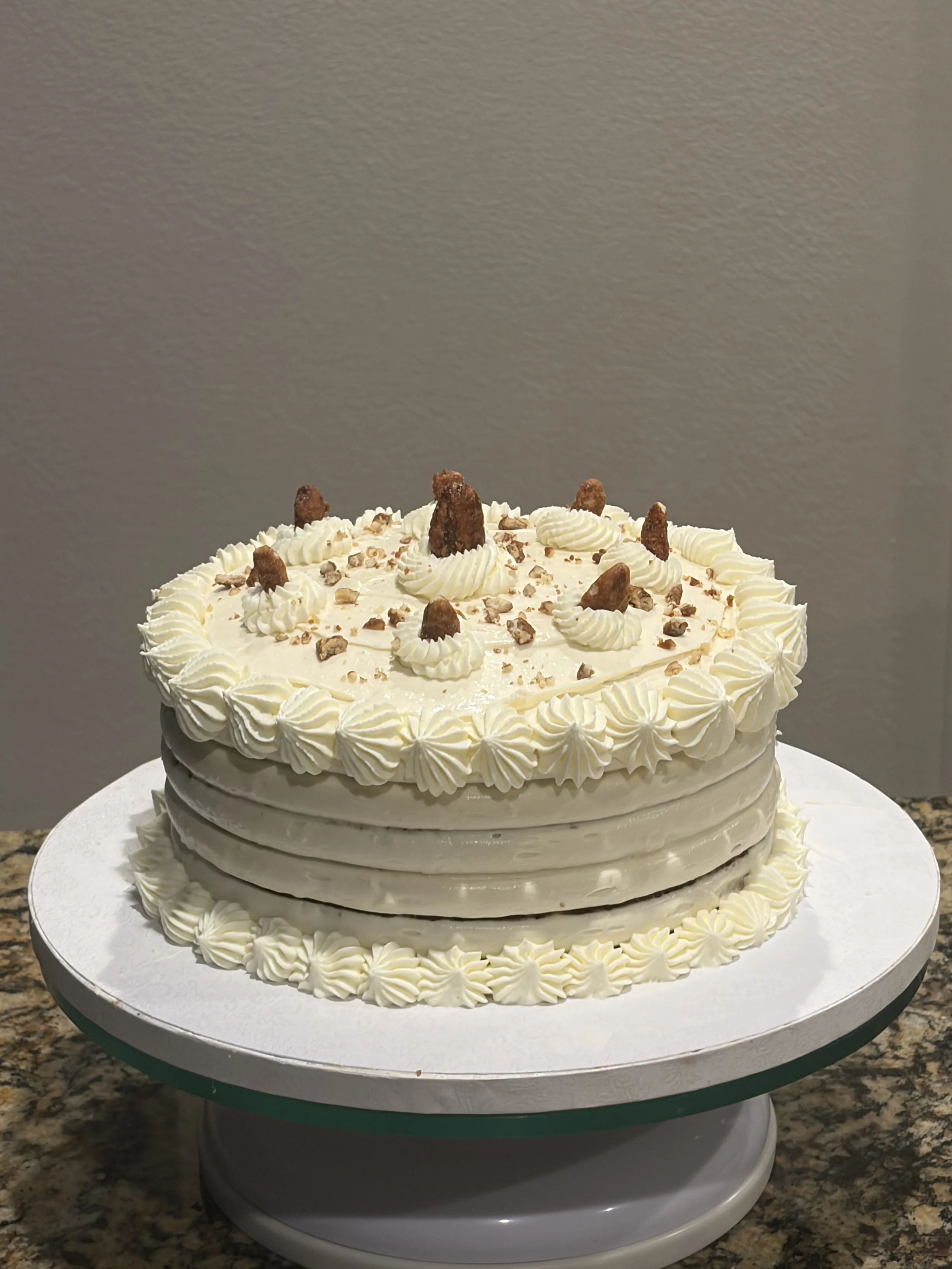 A white ridged cake topped with crumbled cookie pieces.