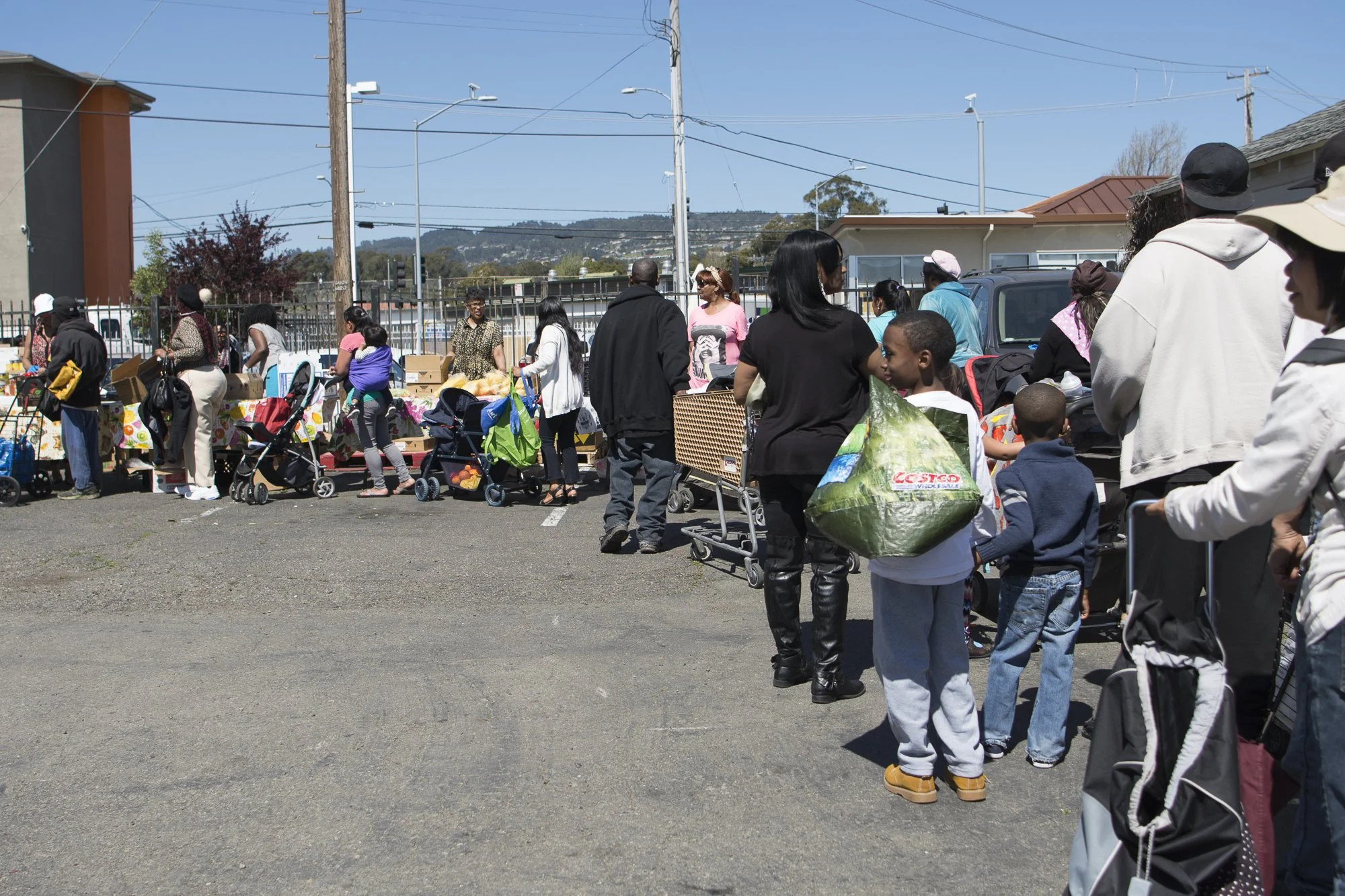 Community members wait for groceries at the Faith Baptist Church in Oakland.