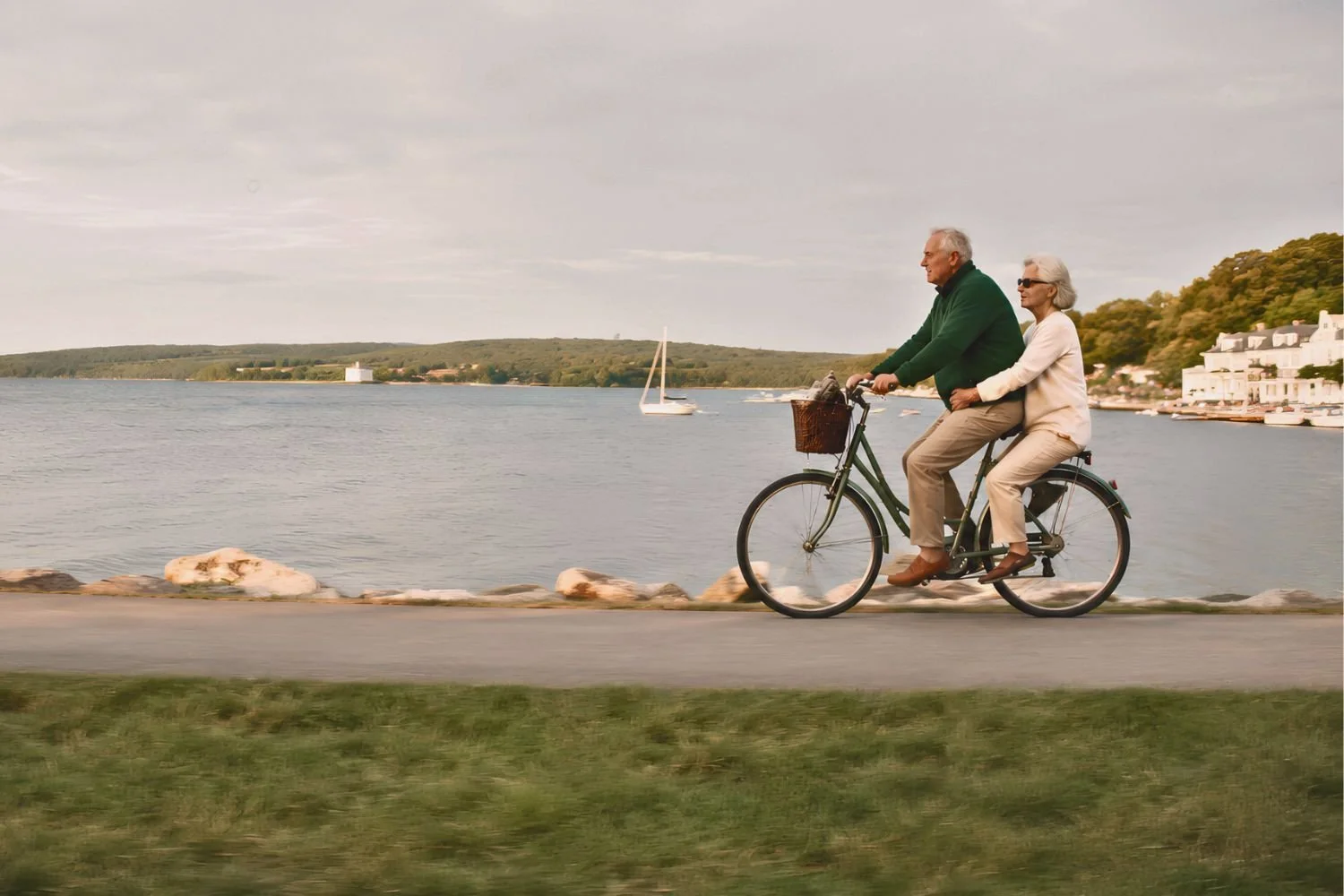 An active retired couple riding a tandem bicycle along a scenic Michigan lakefront.