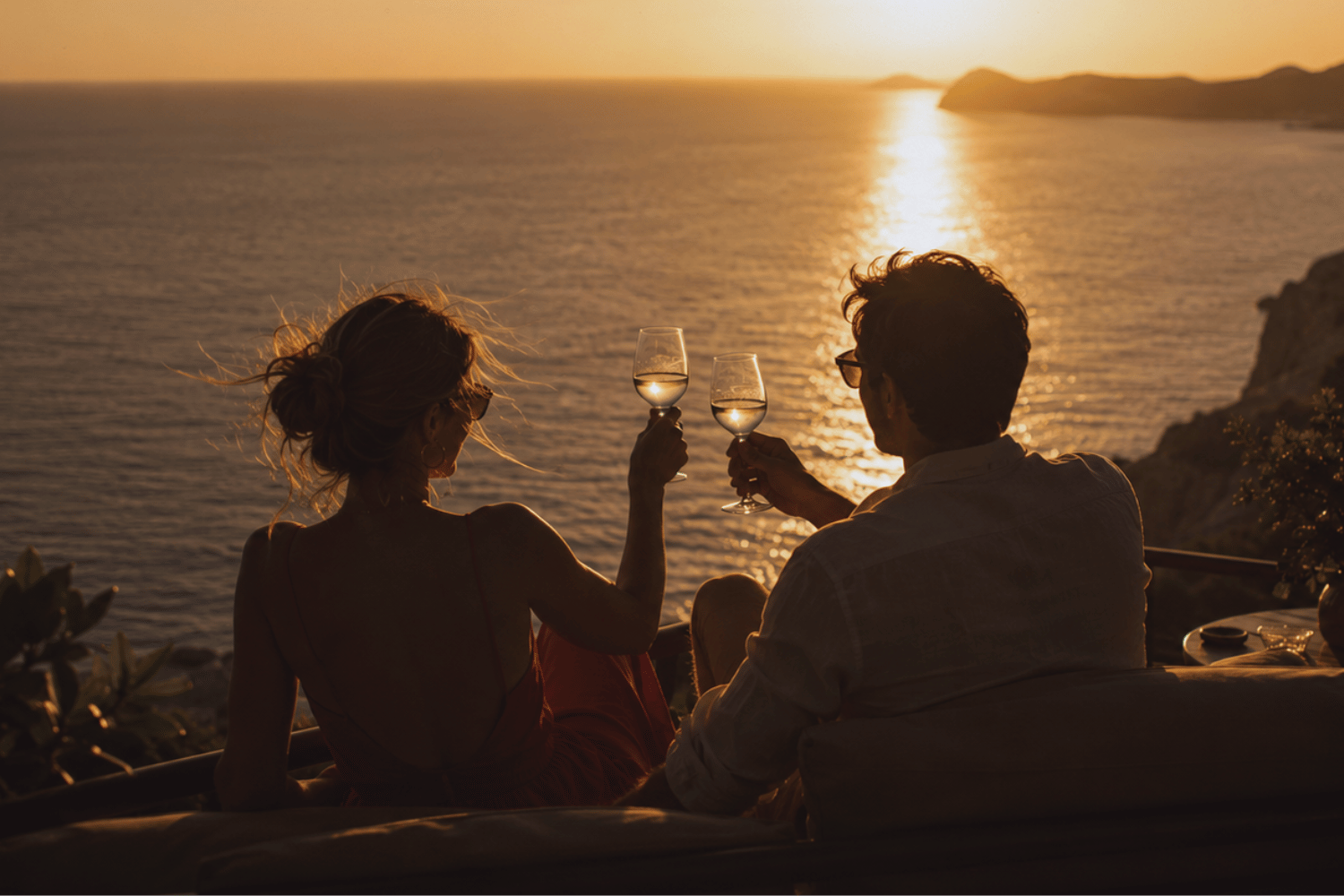 Couple sitting together with wine discussing shared finances and budgeting decisions.