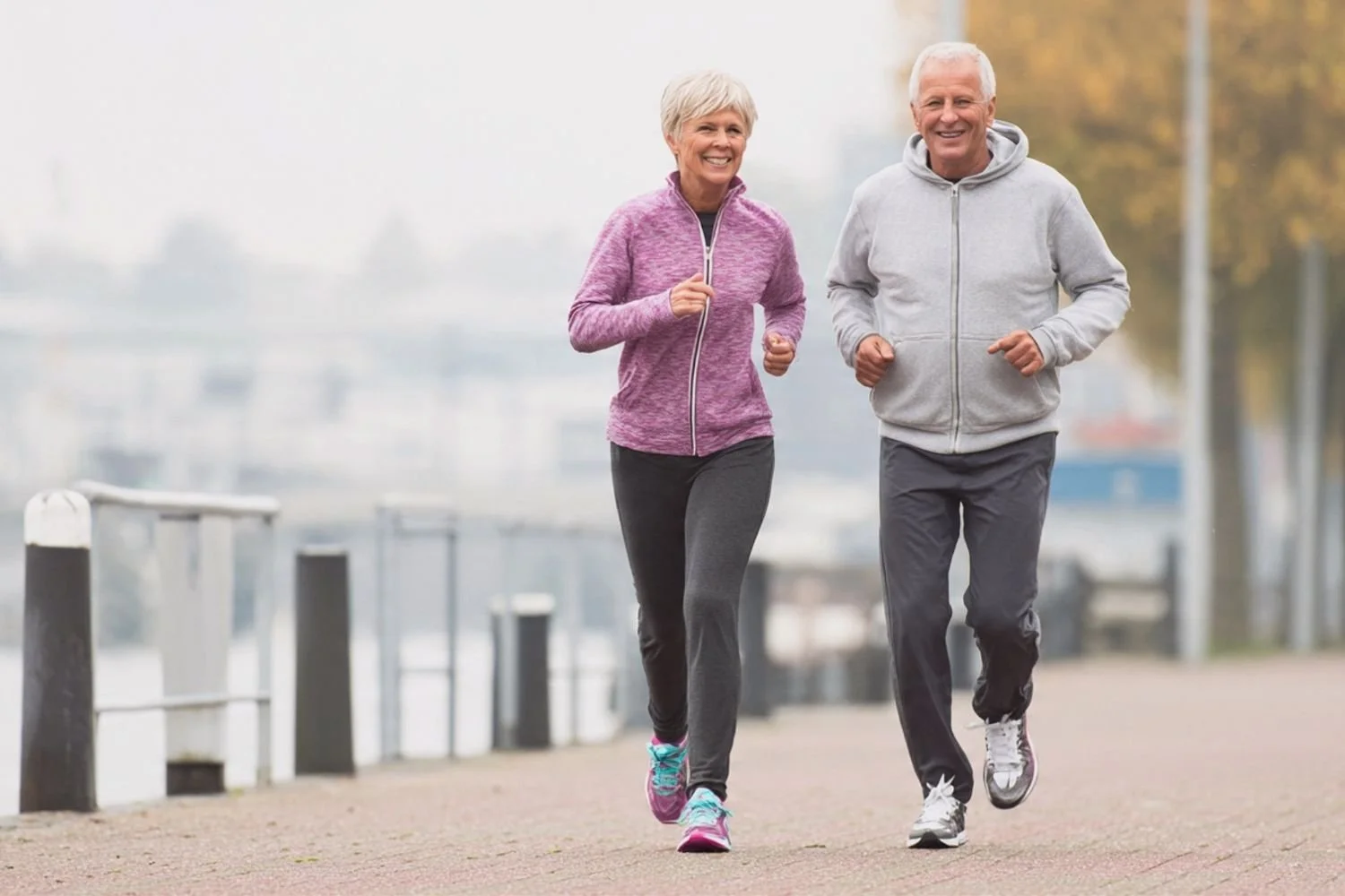 A healthy senior couple jogging outdoors, symbolizing longevity and active retirement planning.