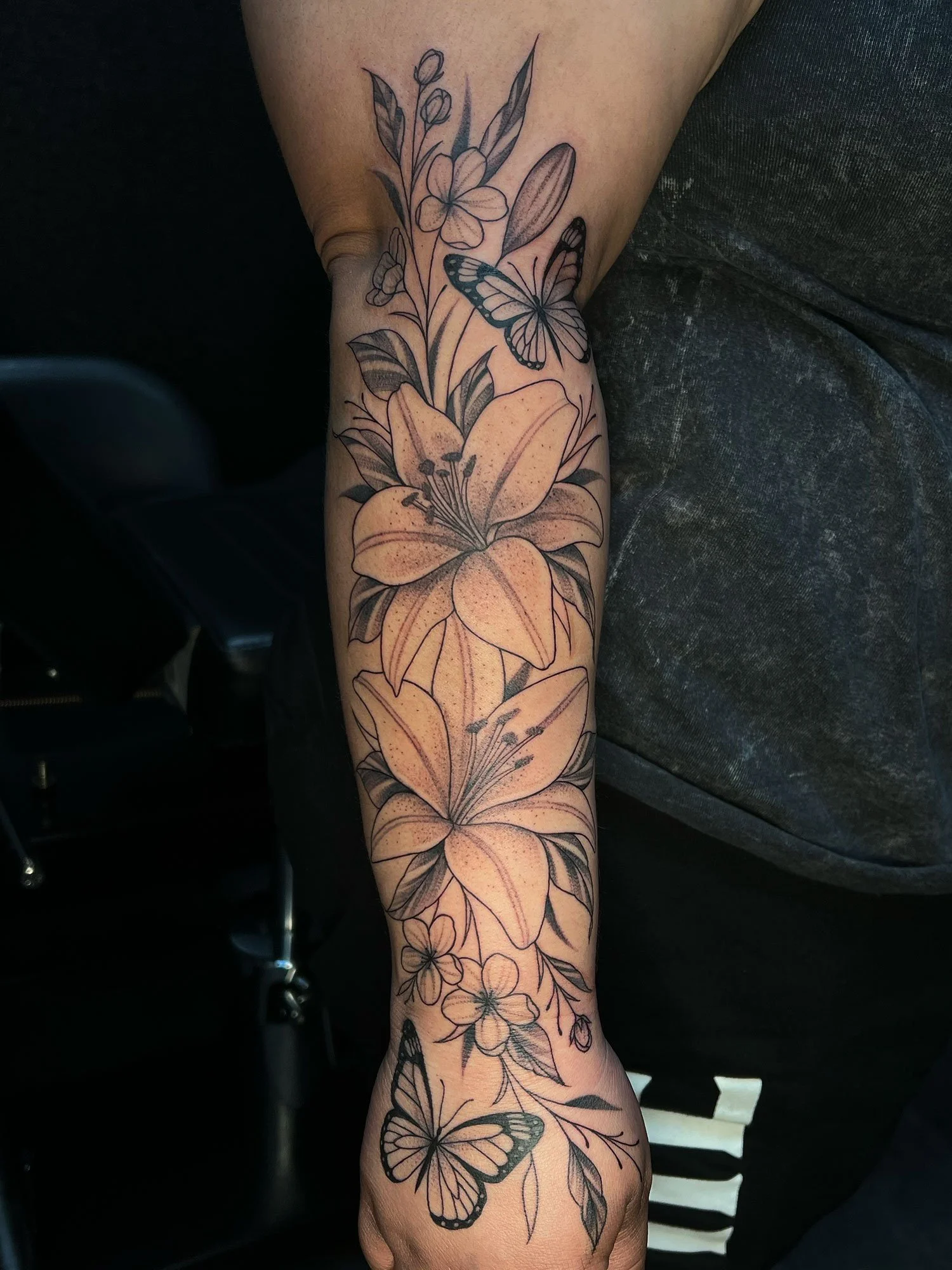 elizagreed-san-diego-black-grey-fineline-lily-floral-arm-tattoo.jpg