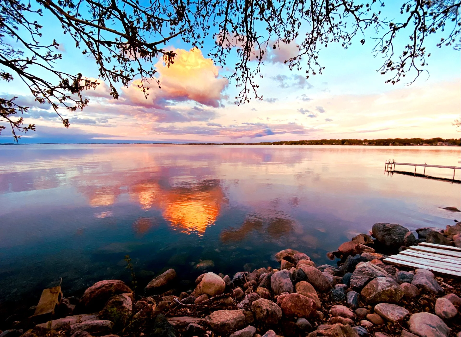 Green Lake during the Golden hour_sky is blue, white, and purple with yellow clouds reflected over the water_Spicer MN