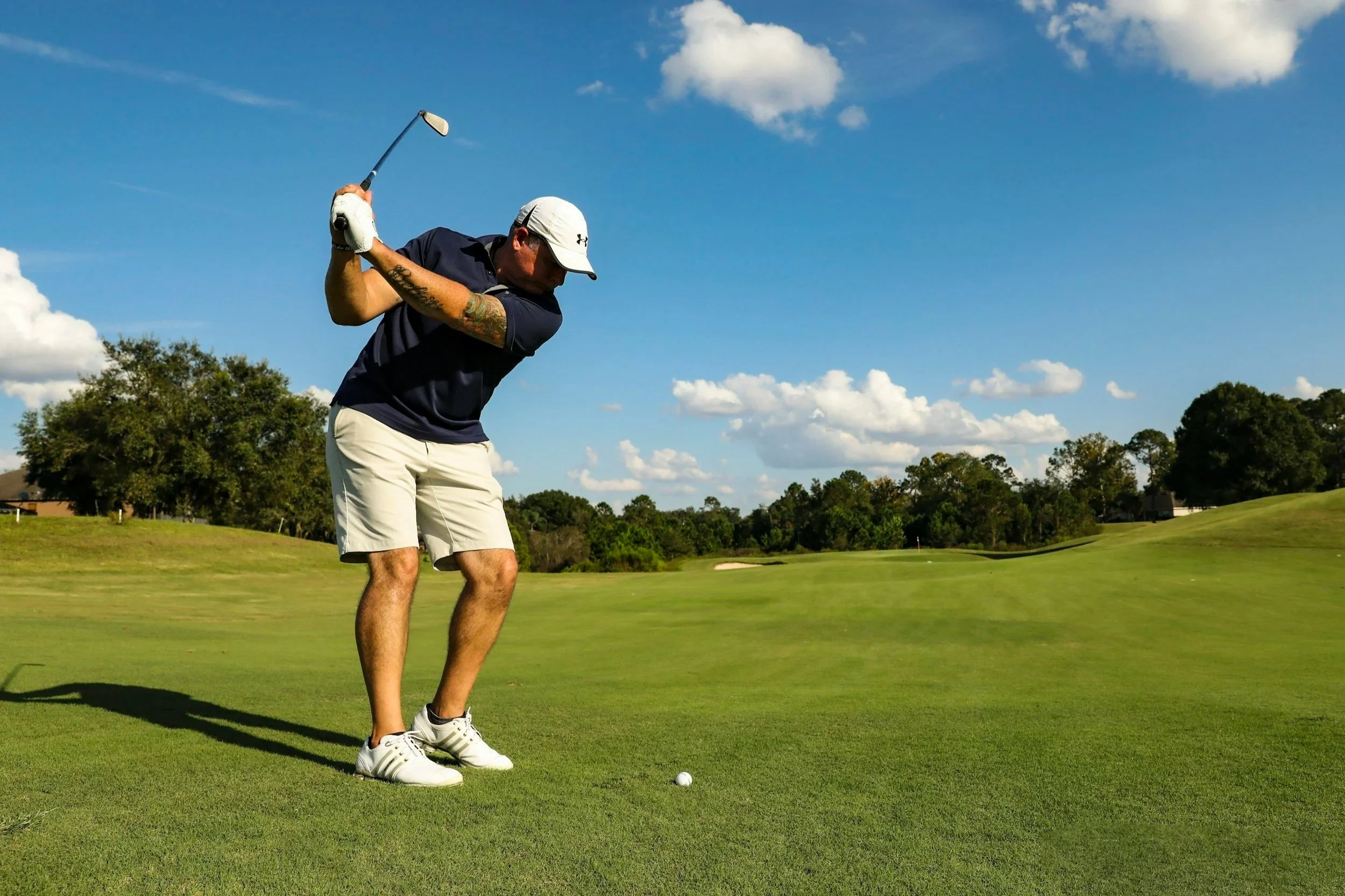 golfer hitting a ball down the fairway in New Zealand