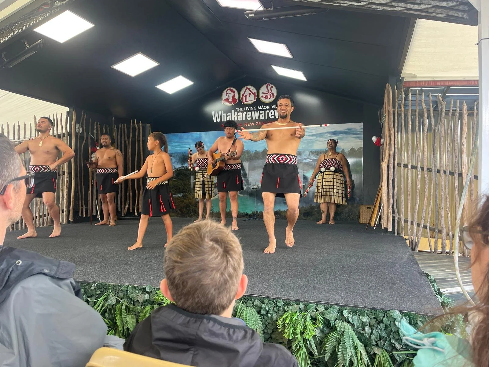 Māori cultural group performing traditional dance and music at Whakarewarewa in Rotorua.