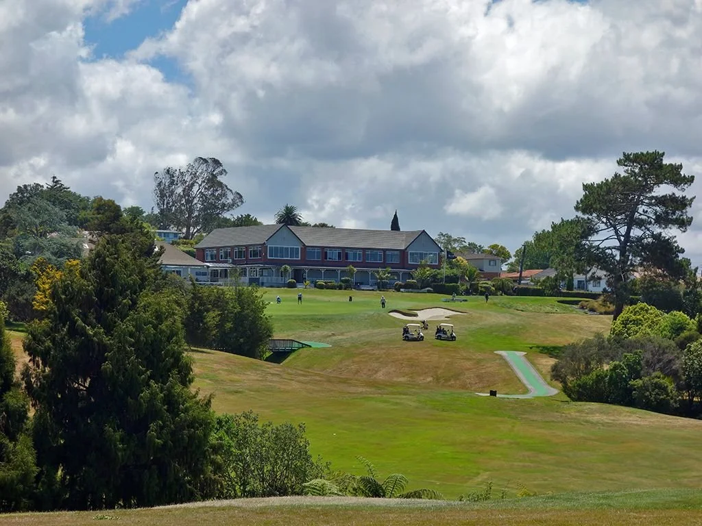 golf course with clubhouse and carts