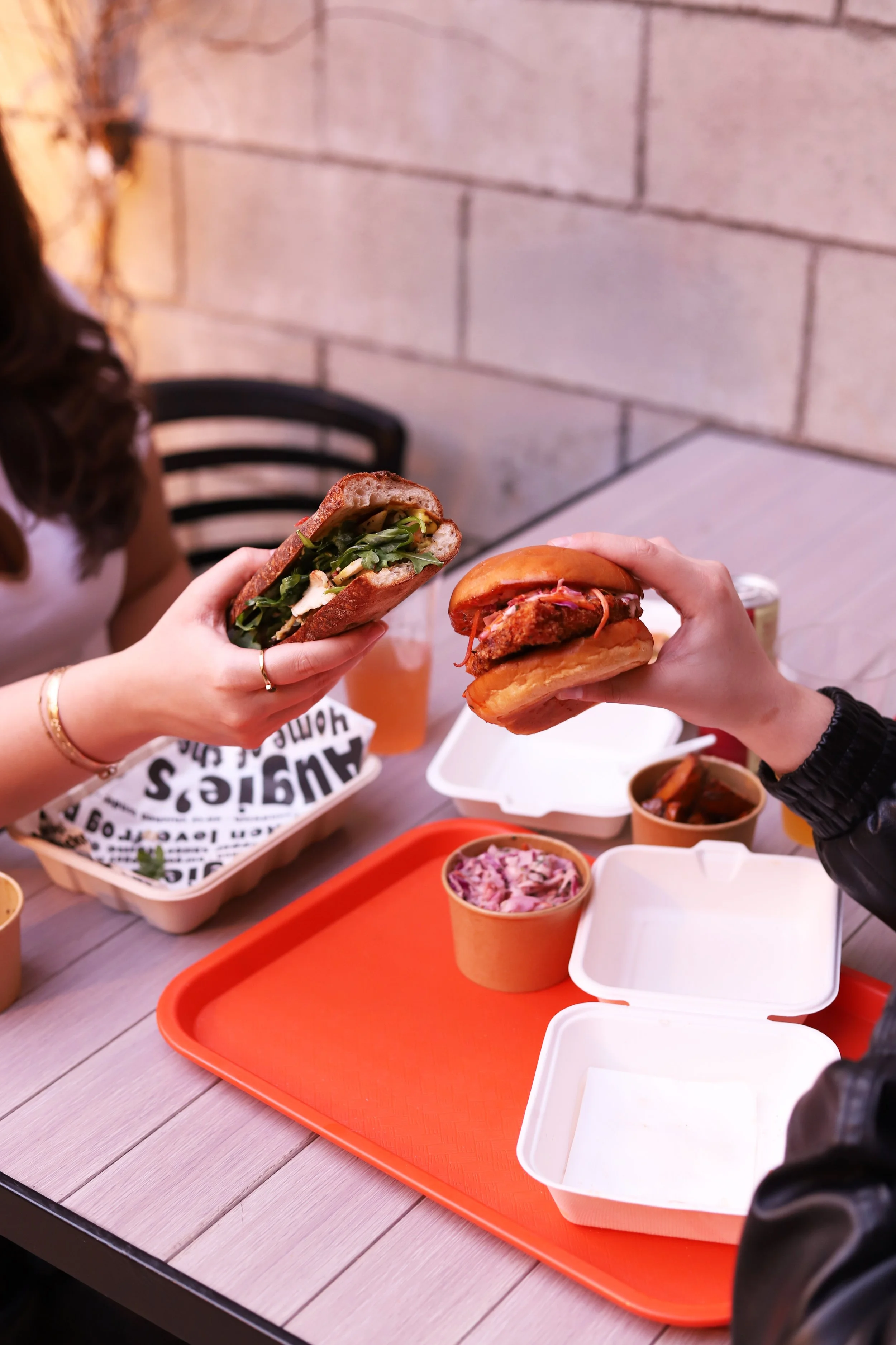 Friends enjoying chicken sandwiches at the best chicken restaurant in Santa Monica