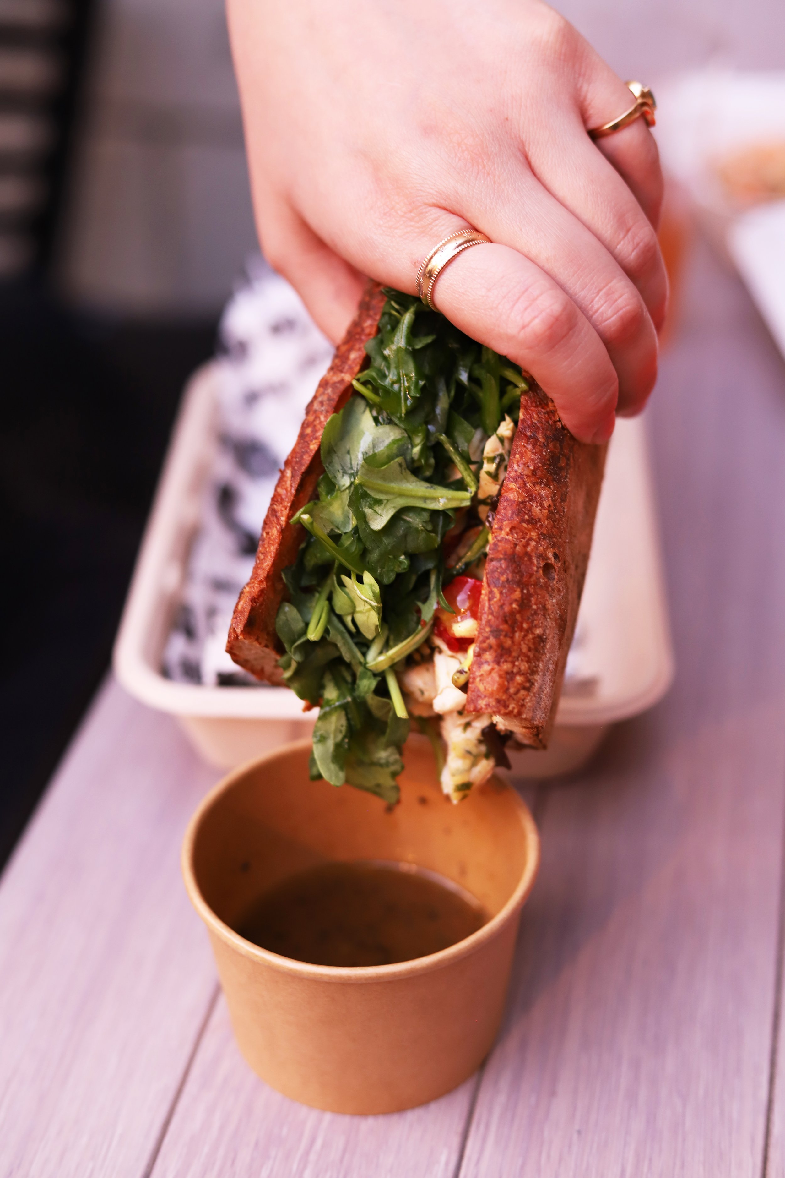 Roast Chicken Sandwich dipping into pan drippings. The best restaurant in Santa Monica.