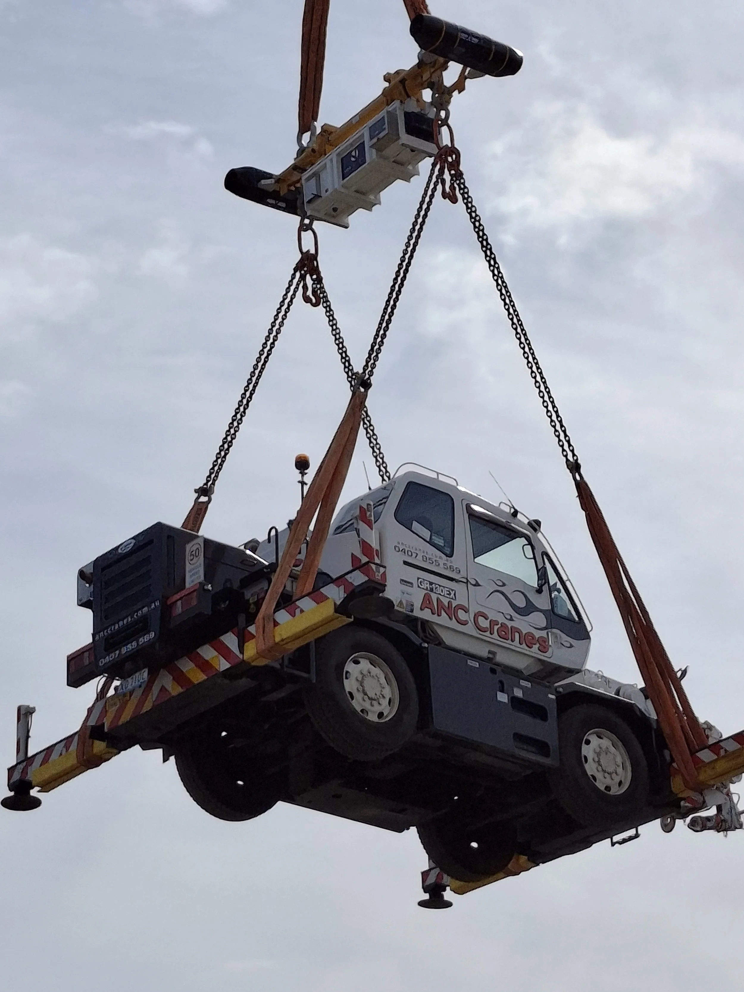 A crane lifting a truck.