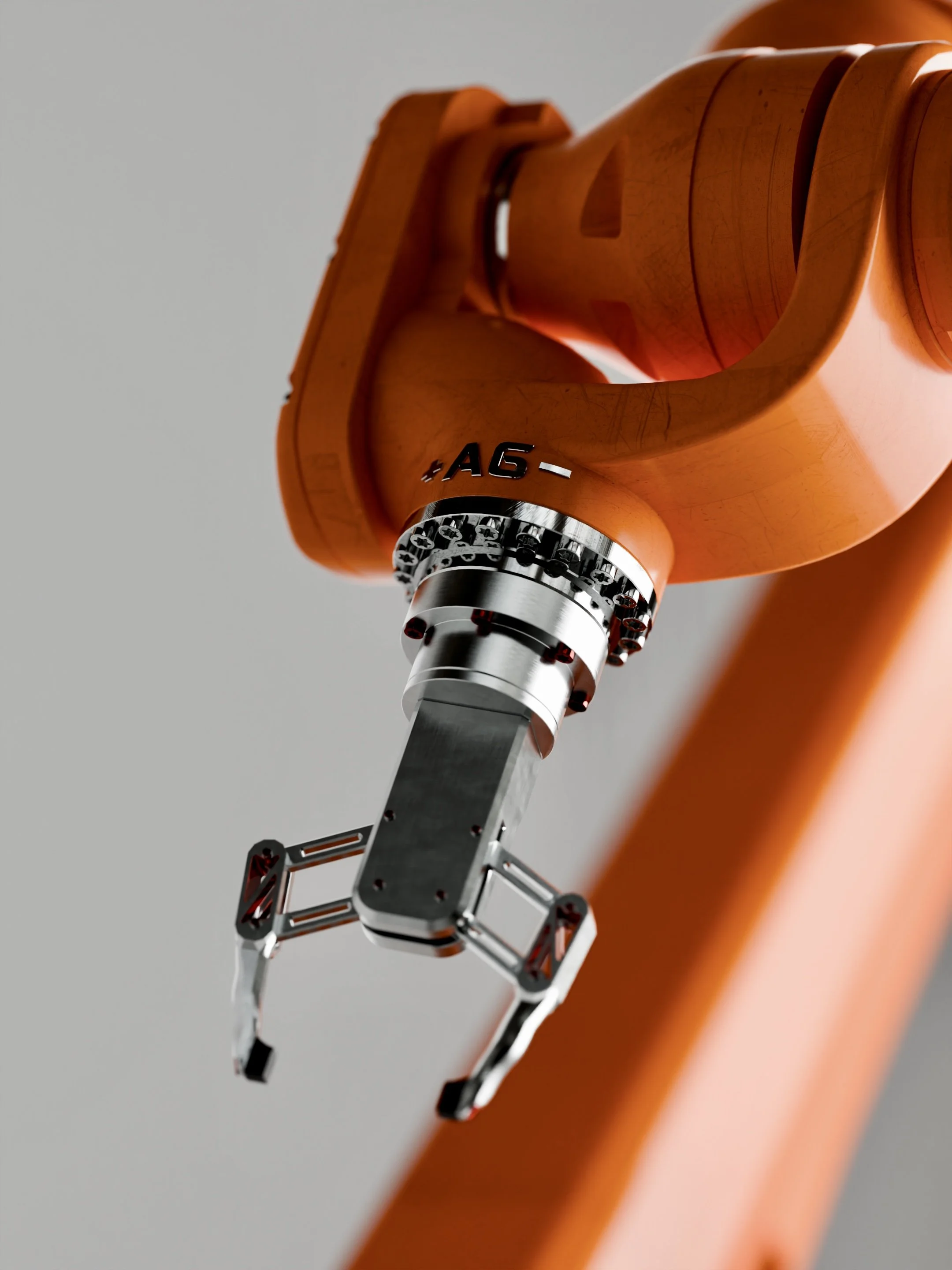 Close-up of a microscope's objective lens and focus ring mounted on an orange and gray microscope frame.