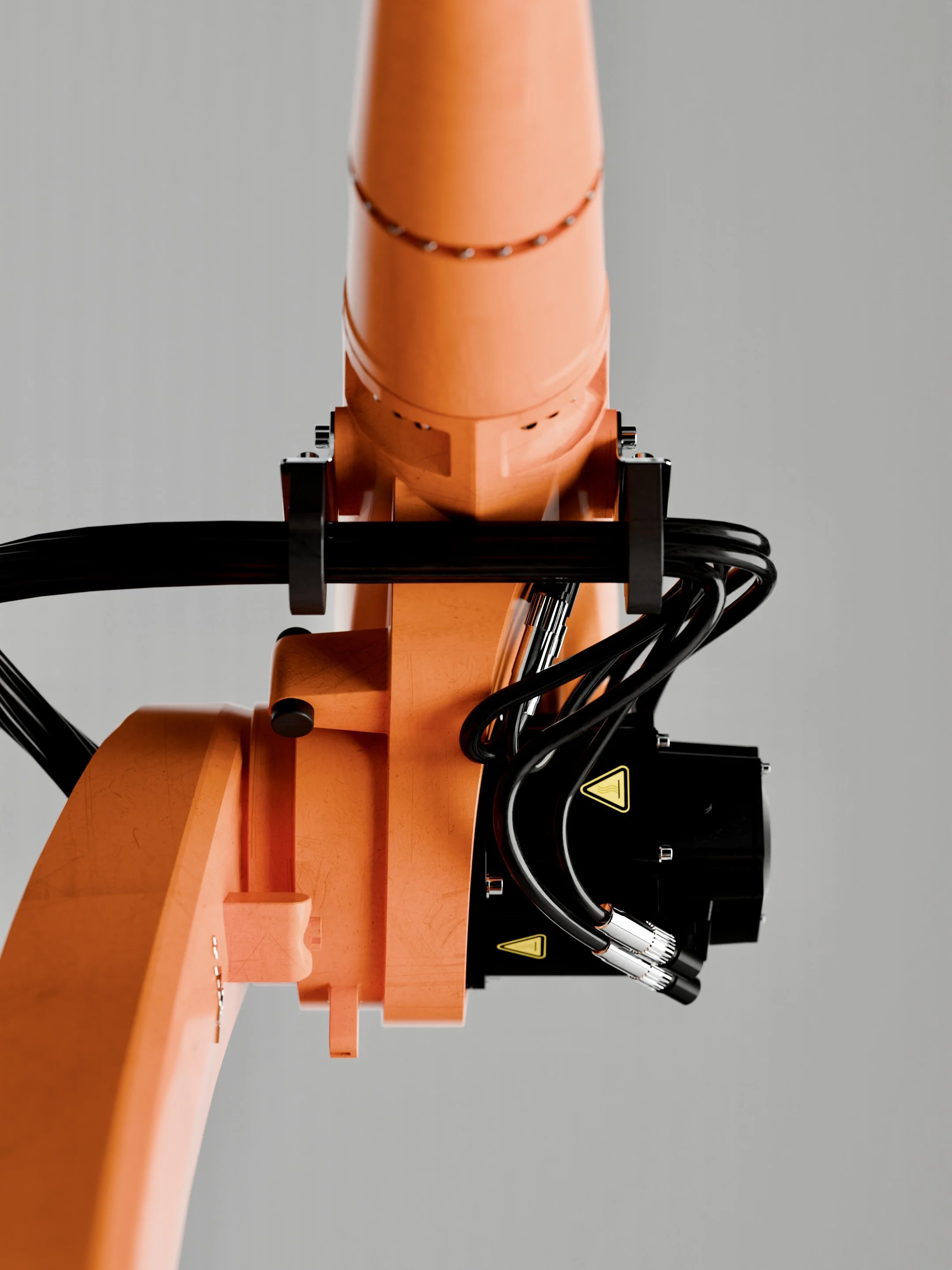 Close-up of an orange robotic arm with black wiring and sensors, set against a plain gray background.