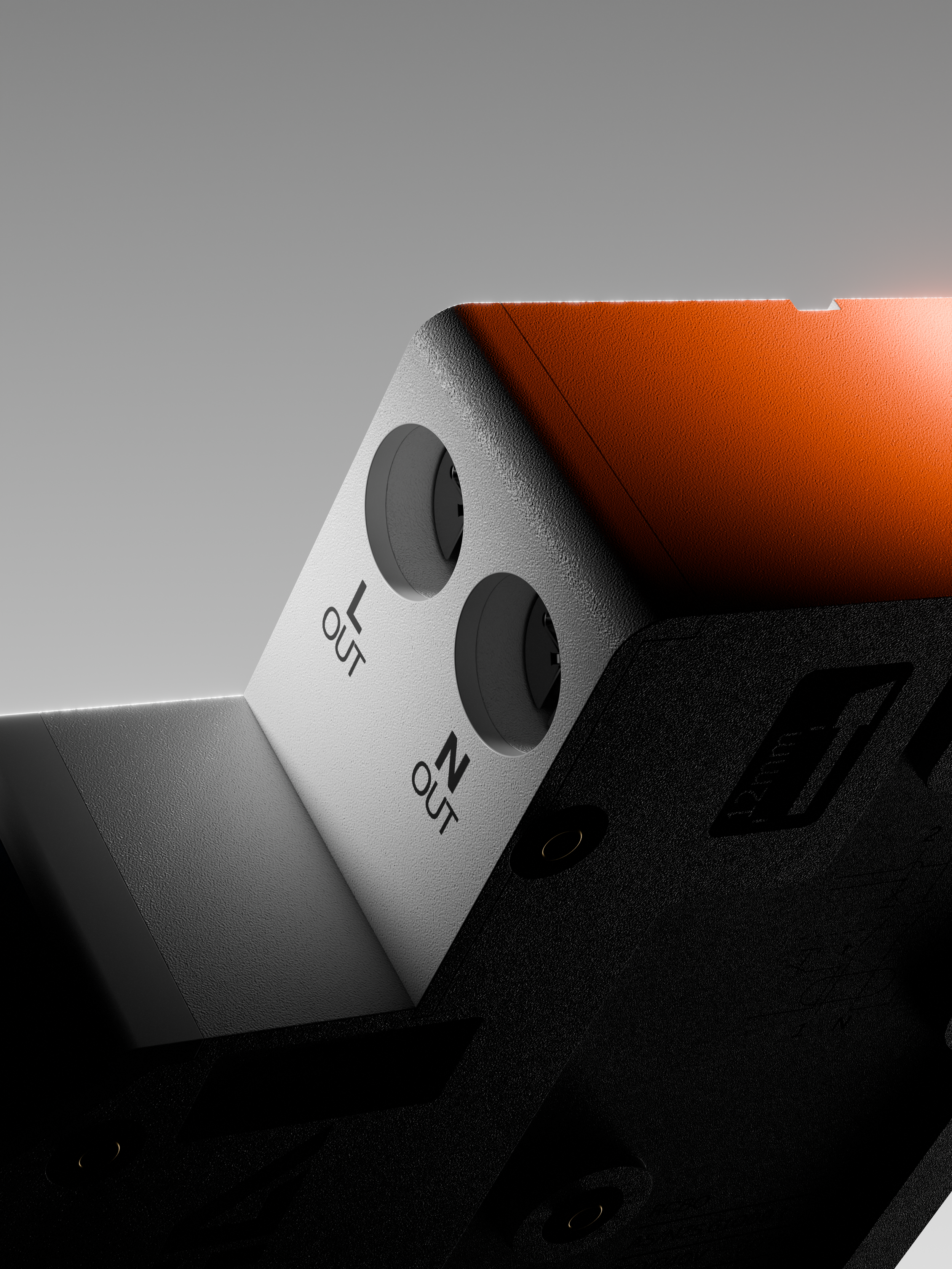 Close-up of a modern electronic device with textured black, white, and orange parts, featuring labeled switches for adjusting volume and mute.