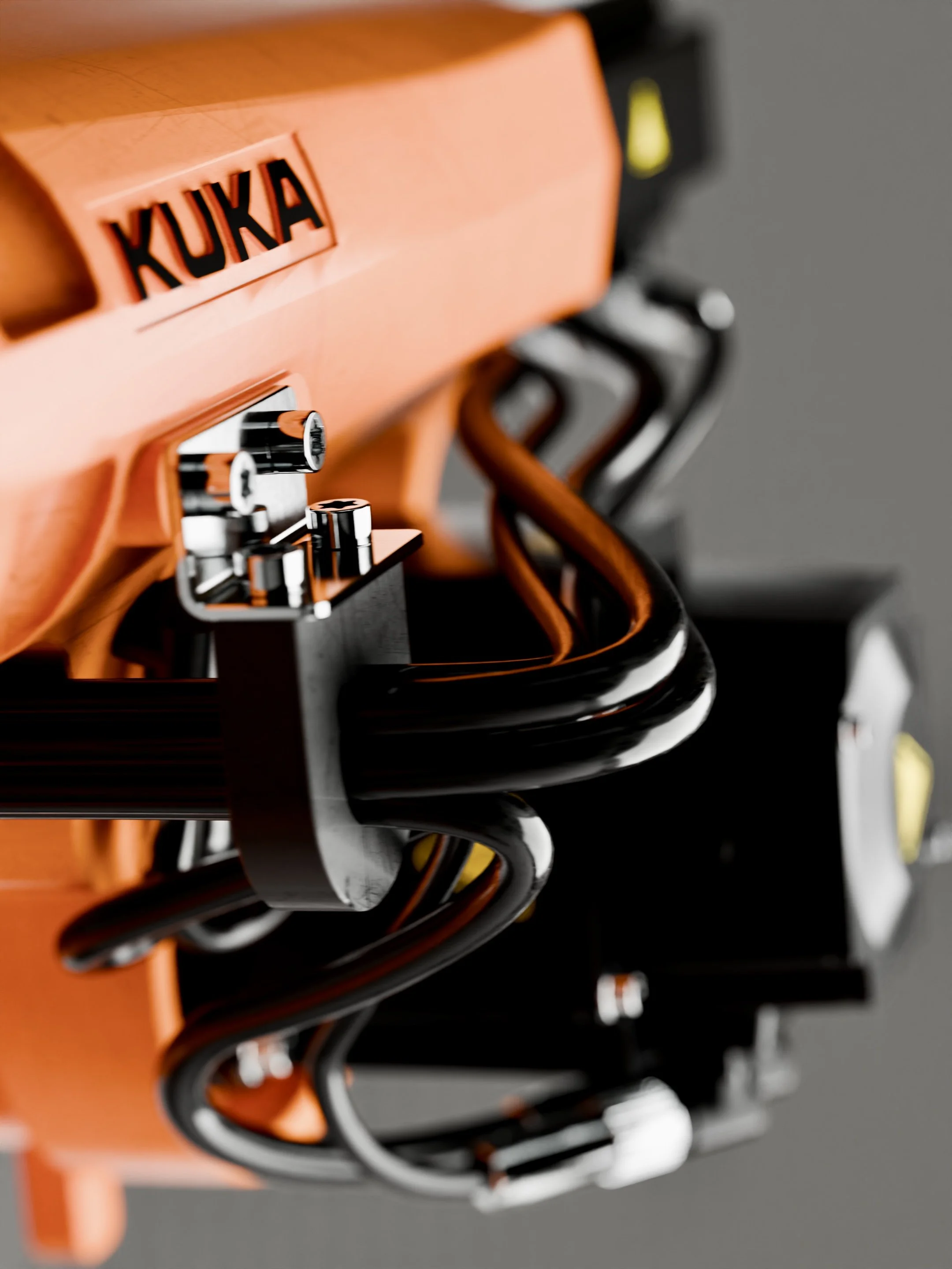 Close-up view of a string of black and gray hooks hanging from a orange holder.