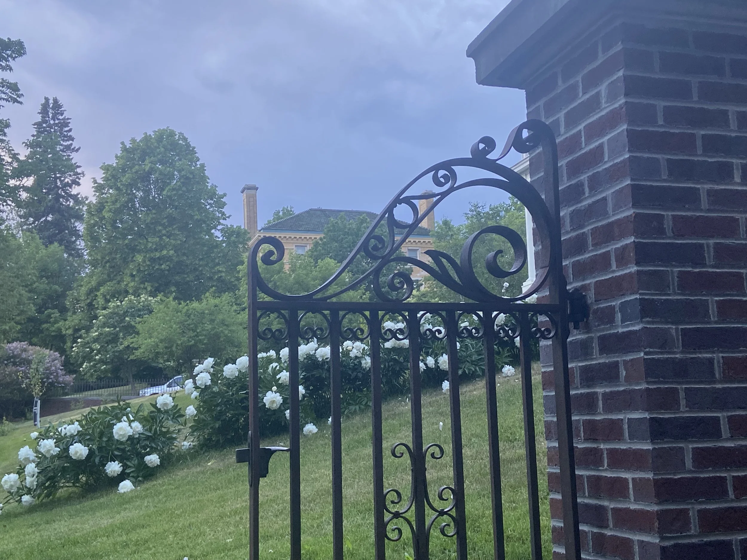 iron decorative gate and peonies at the merryweather inn