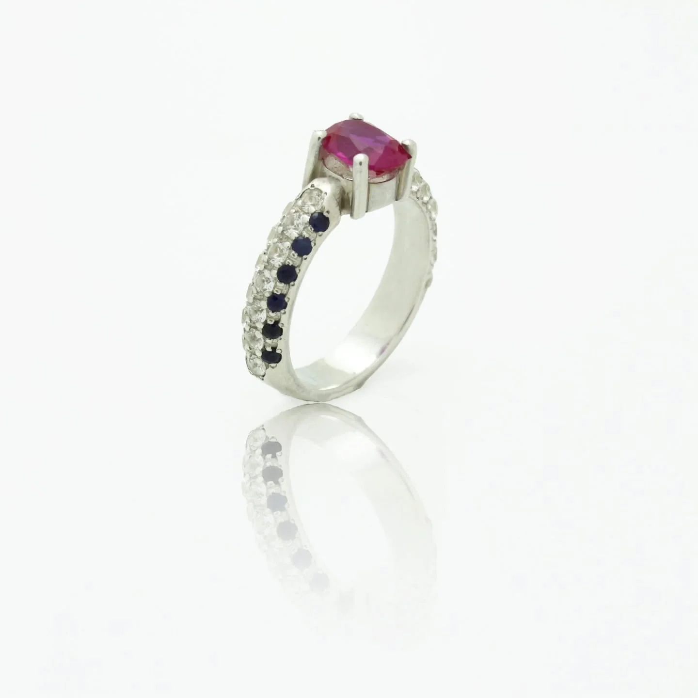 For the woman who isn't afraid to command the room.
Why choose between fire and ice? This stunning handcrafted ring celebrates the power of contrast. The passionate, oval-cut ruby is the undeniable star, while cascading rows of brilliant diamonds an