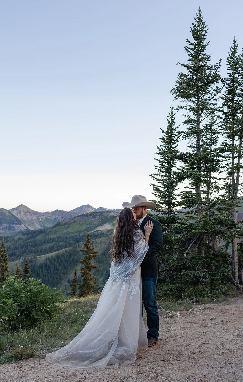 Couple posing on a mountain pass in Crested Butte, Colorado during their wedding. Photography by Trail Magic Elopements and Micro Weddings.