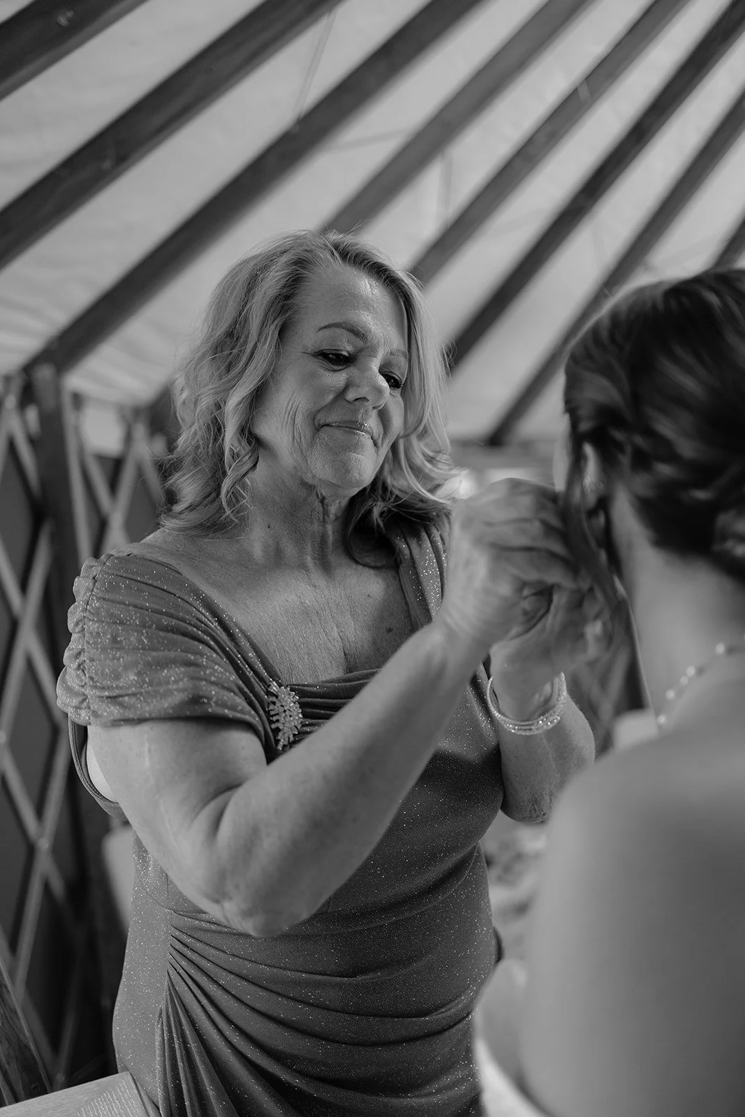 Mother helping bride with earring before her wedding. Photography by Trail Magic Elopements and Micro Weddings.