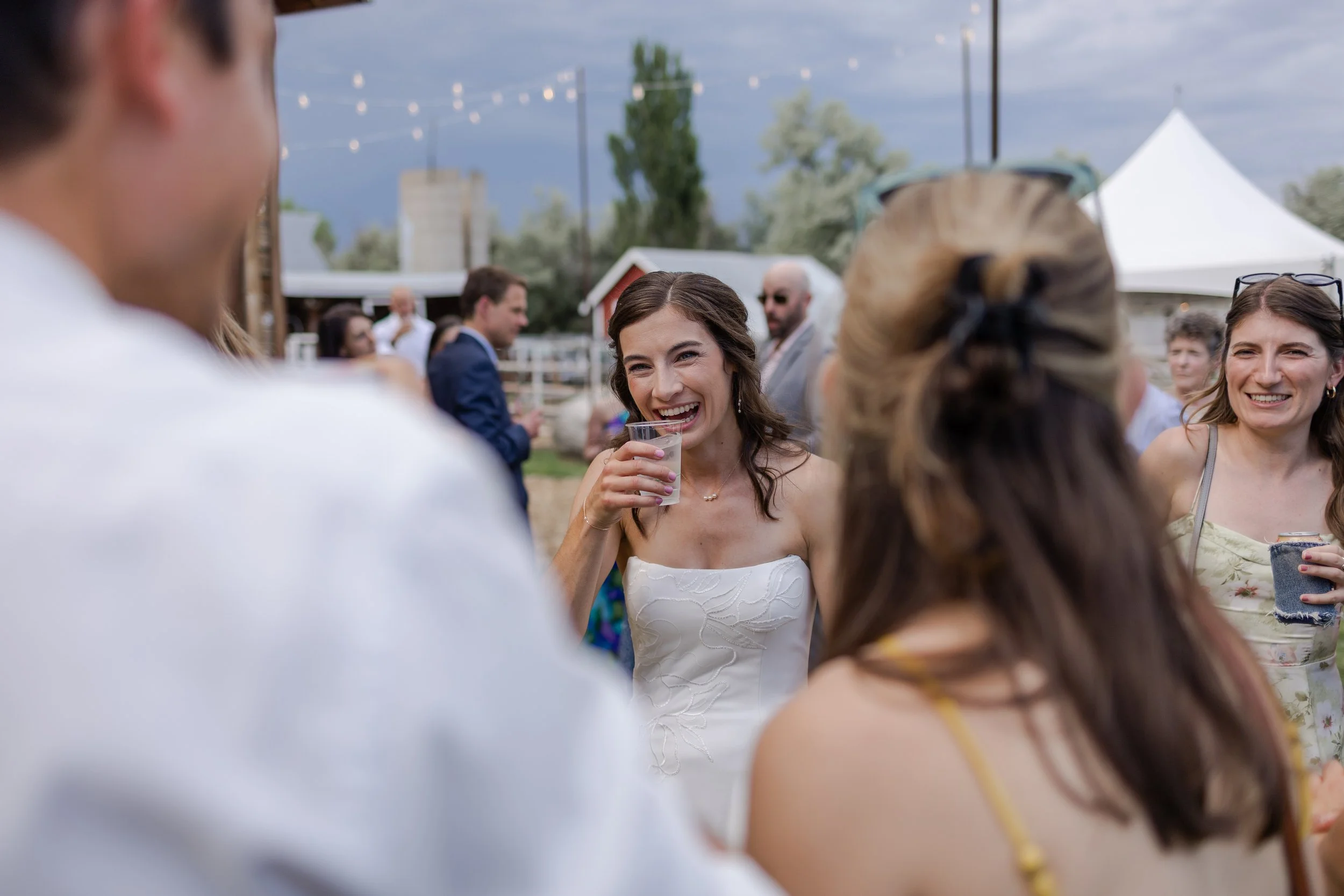 Cocktail hour candids with bride at her non-traditional micro wedding in Longmont, Colorado. Photography by Trail Magic Elopements and Micro Weddings.