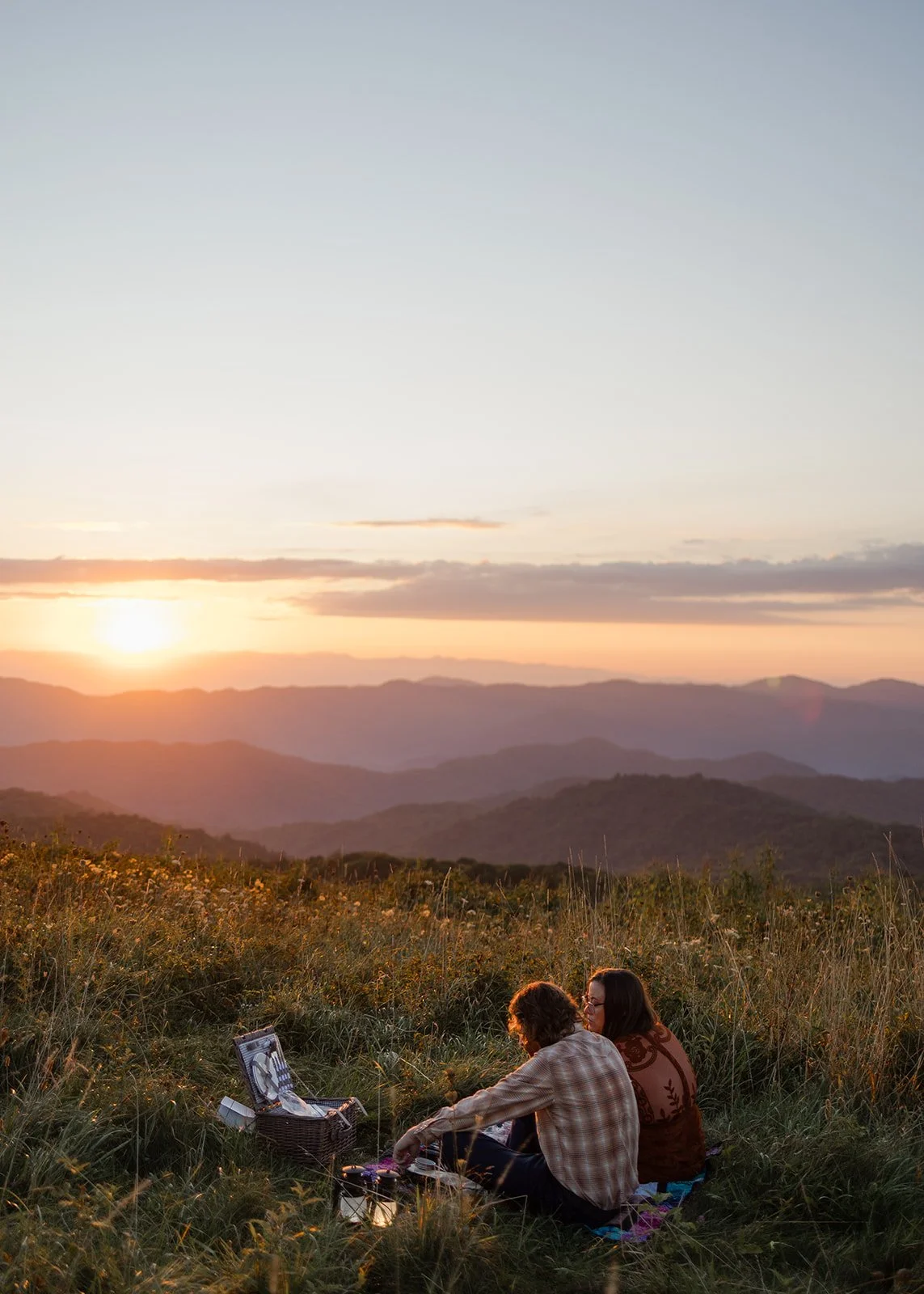 Couple reading private vows at sunrise on Max Patch before their micro wedding ceremony at the Heavens in North Carolina. Photography by Trail Magic Elopements and Micro Weddings.