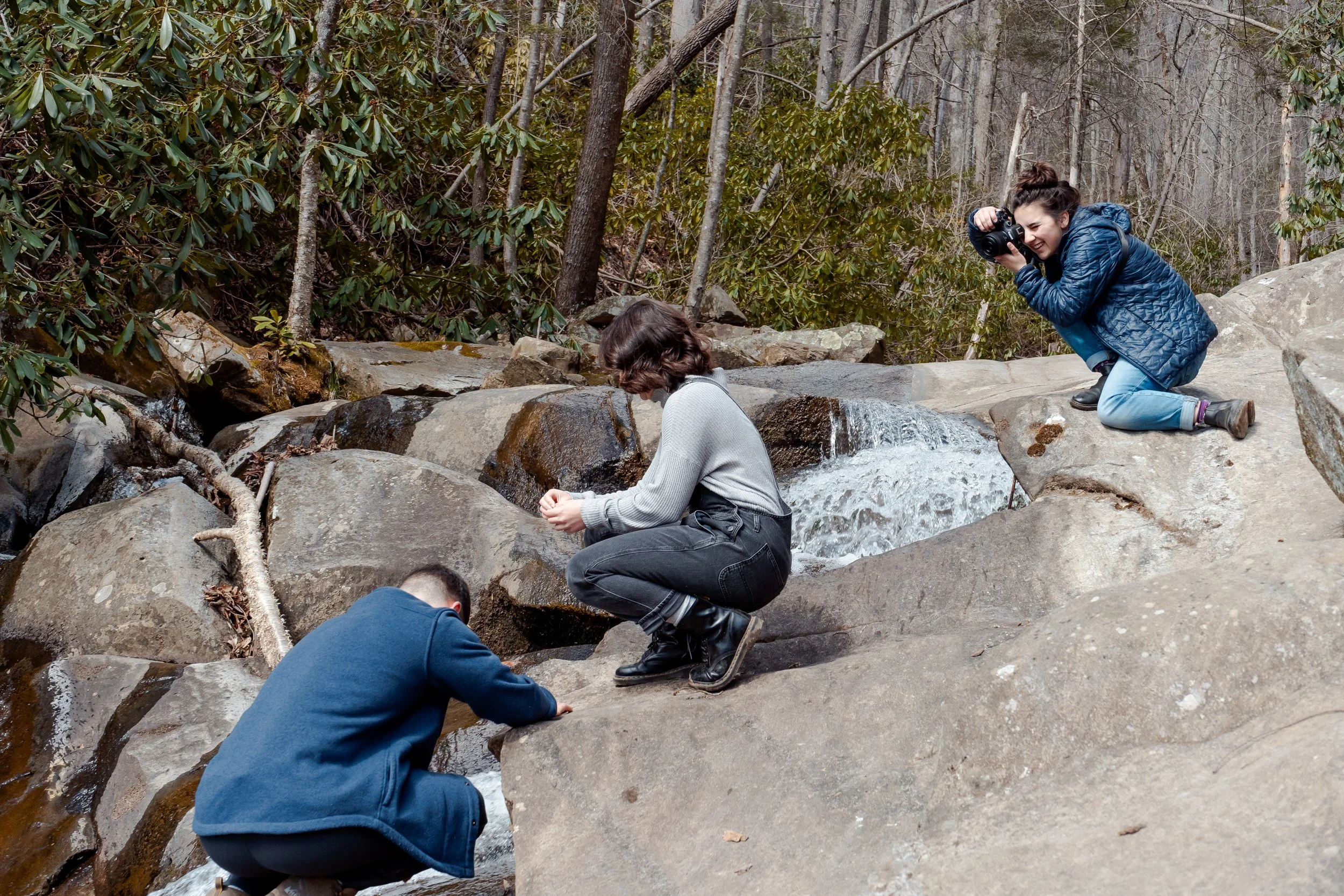 Elopement photographer capturing a couple hiking at a waterfall in Blowing Rock, NC. Photography by Trail Magic Elopements and Micro Weddings.