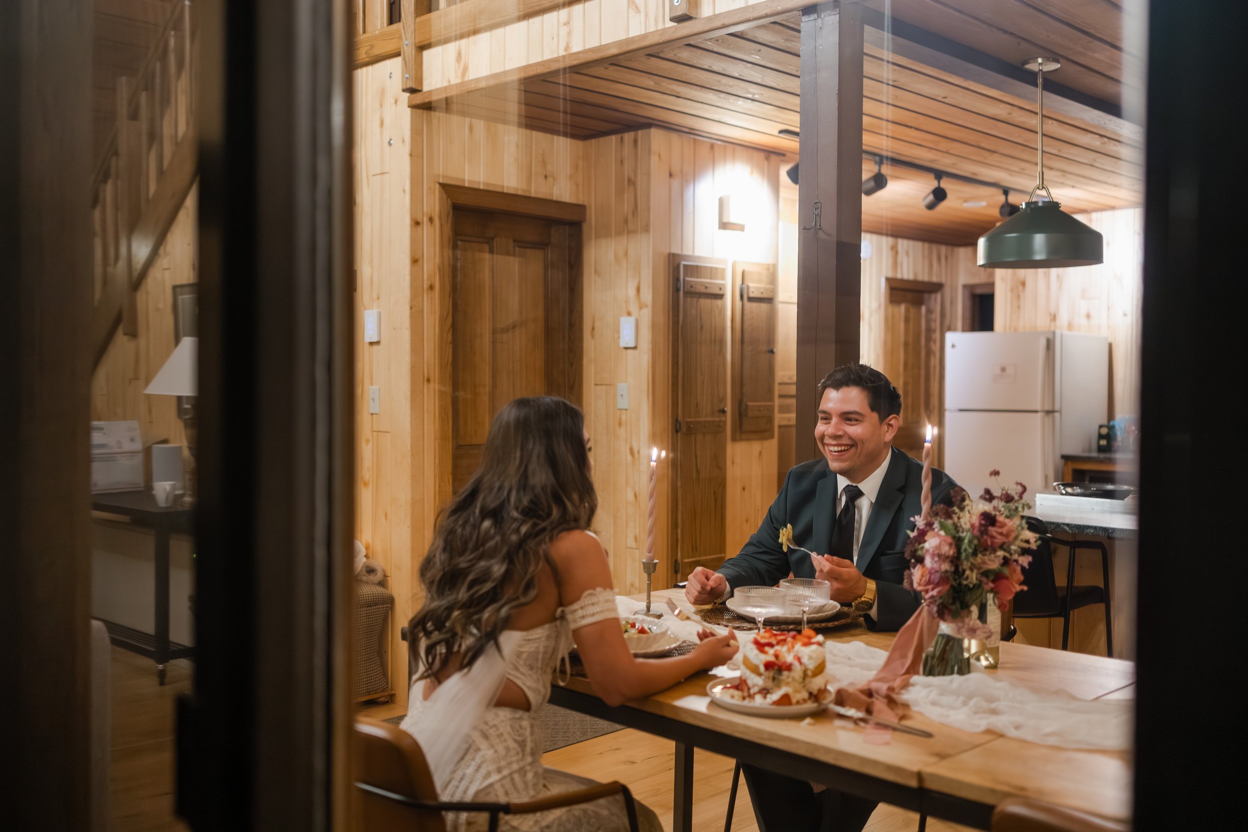 Couple sharing a homecooked meal to end their elopement day in the San Juan Mountains. Photography by Trail Magic Elopements and Micro Weddings.