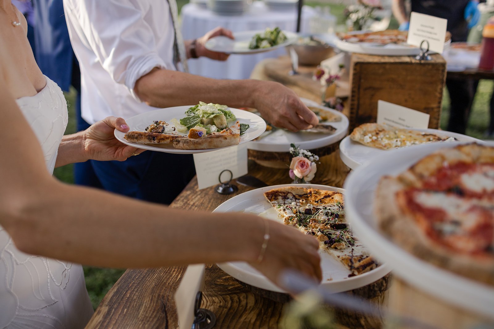 Serve your own pizza station at this couple's non-traditional micro wedding celebration in Longmont, Colorado. Photography by Trail Magic Elopements and Micro Weddings.