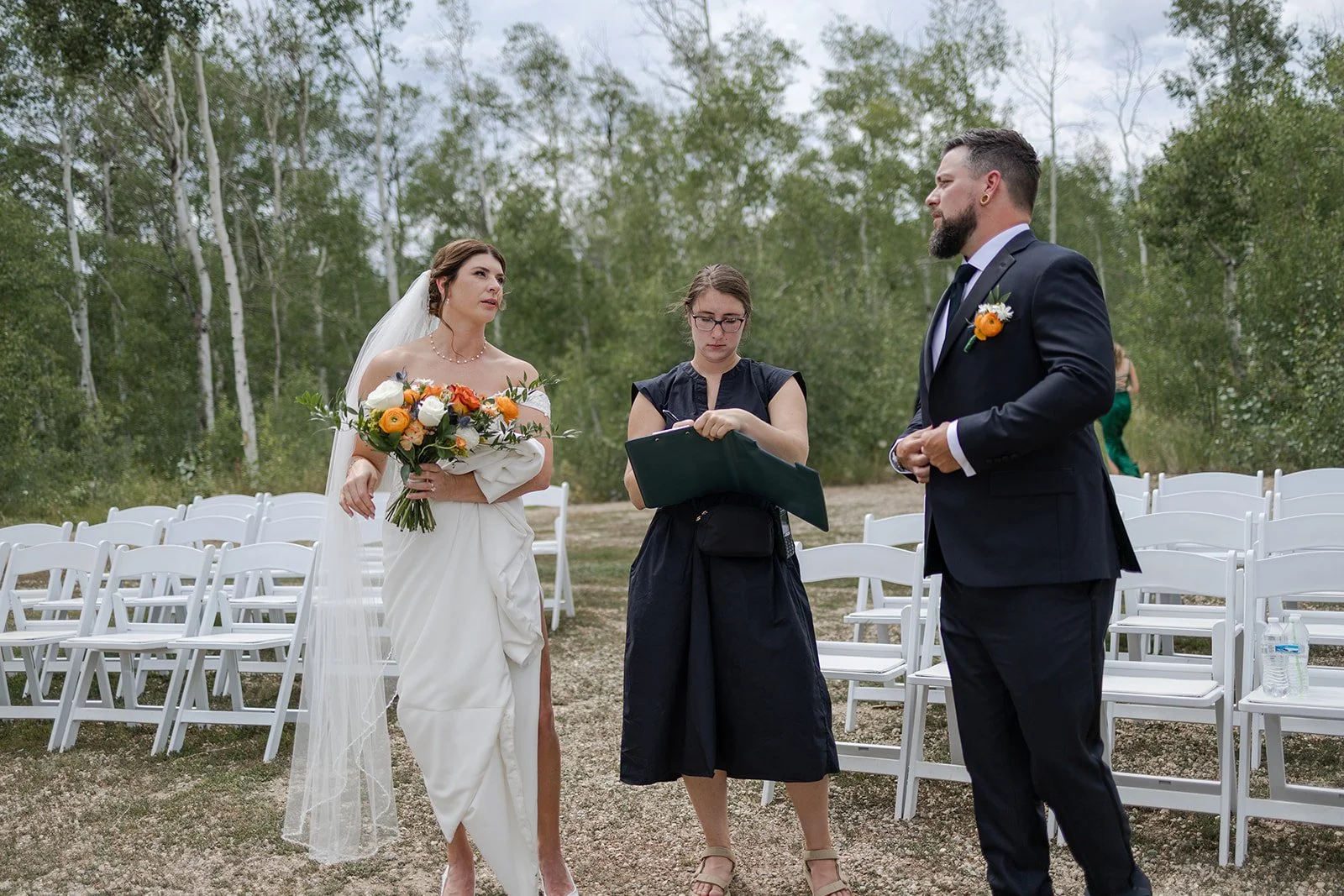 Couple discussing ceremony pathways with their Day-of-Coordinator at their wedding. Photography and Coordination by Trail Magic Elopements and Micro Weddings.